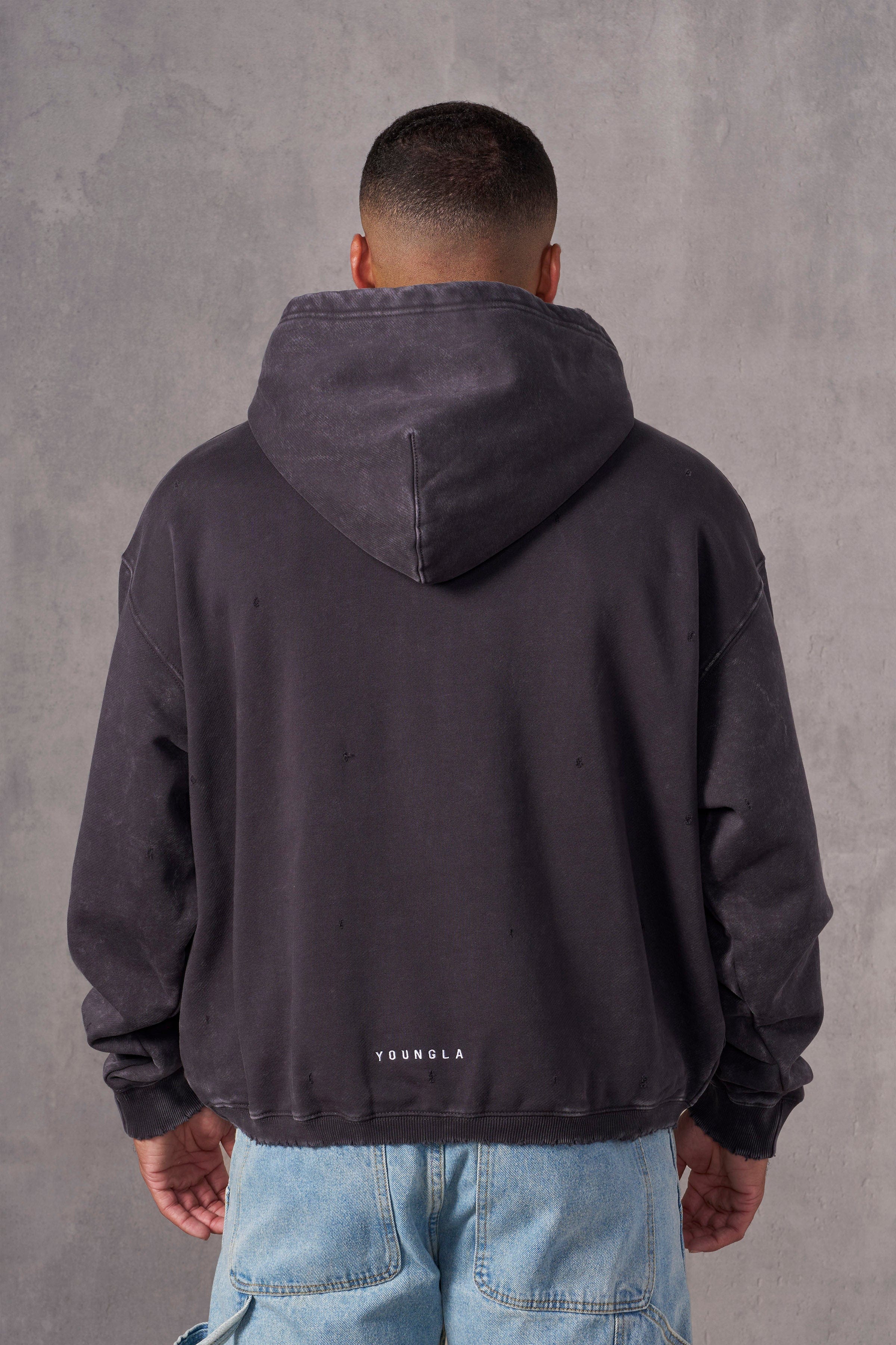 Model in oversized hoodie men’s fit showing cuff and waistband details
