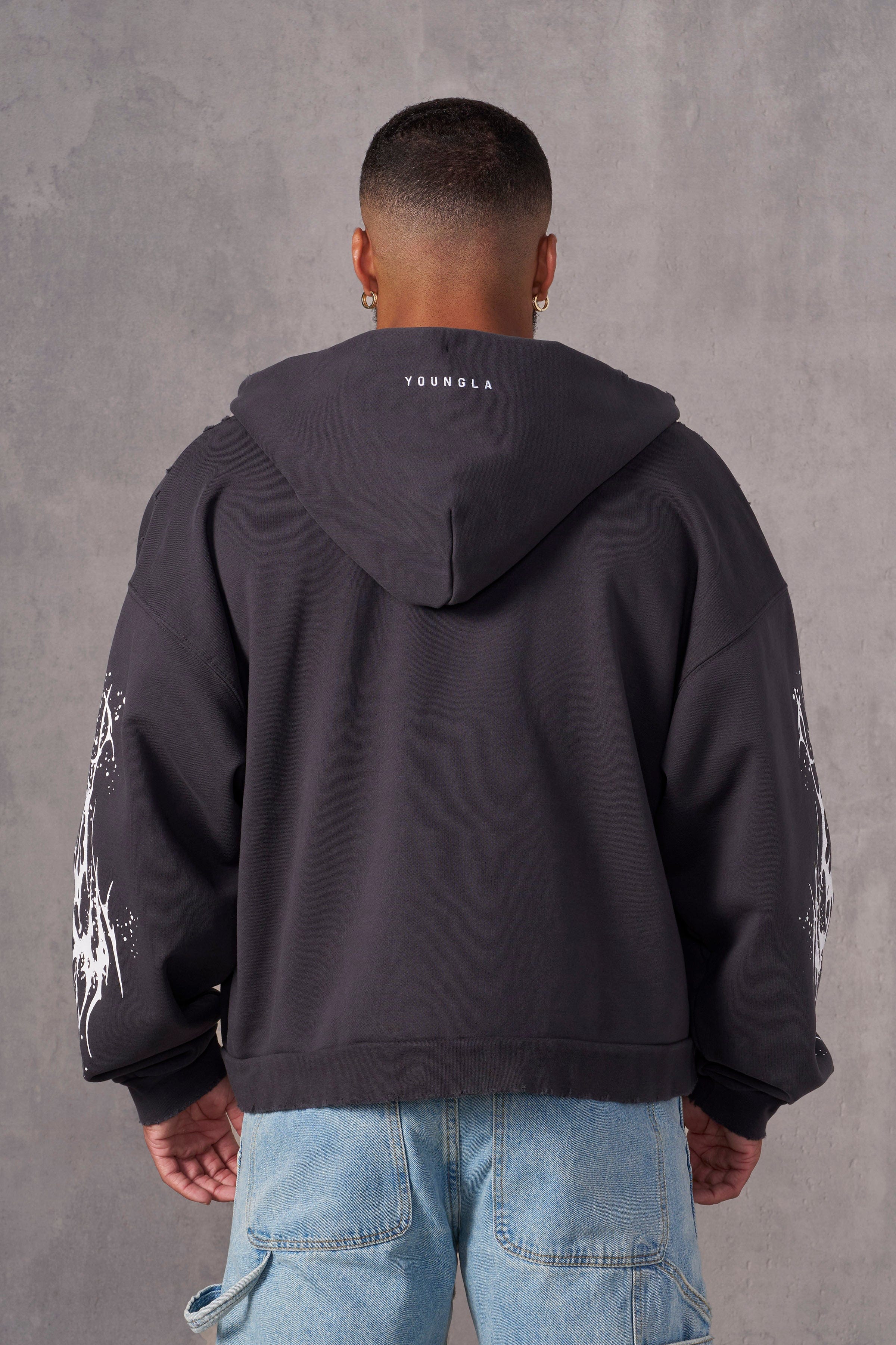 Close-up of tribal graphics on the sleeve of the Venom hoodie, highlighting detailed design and crackle print