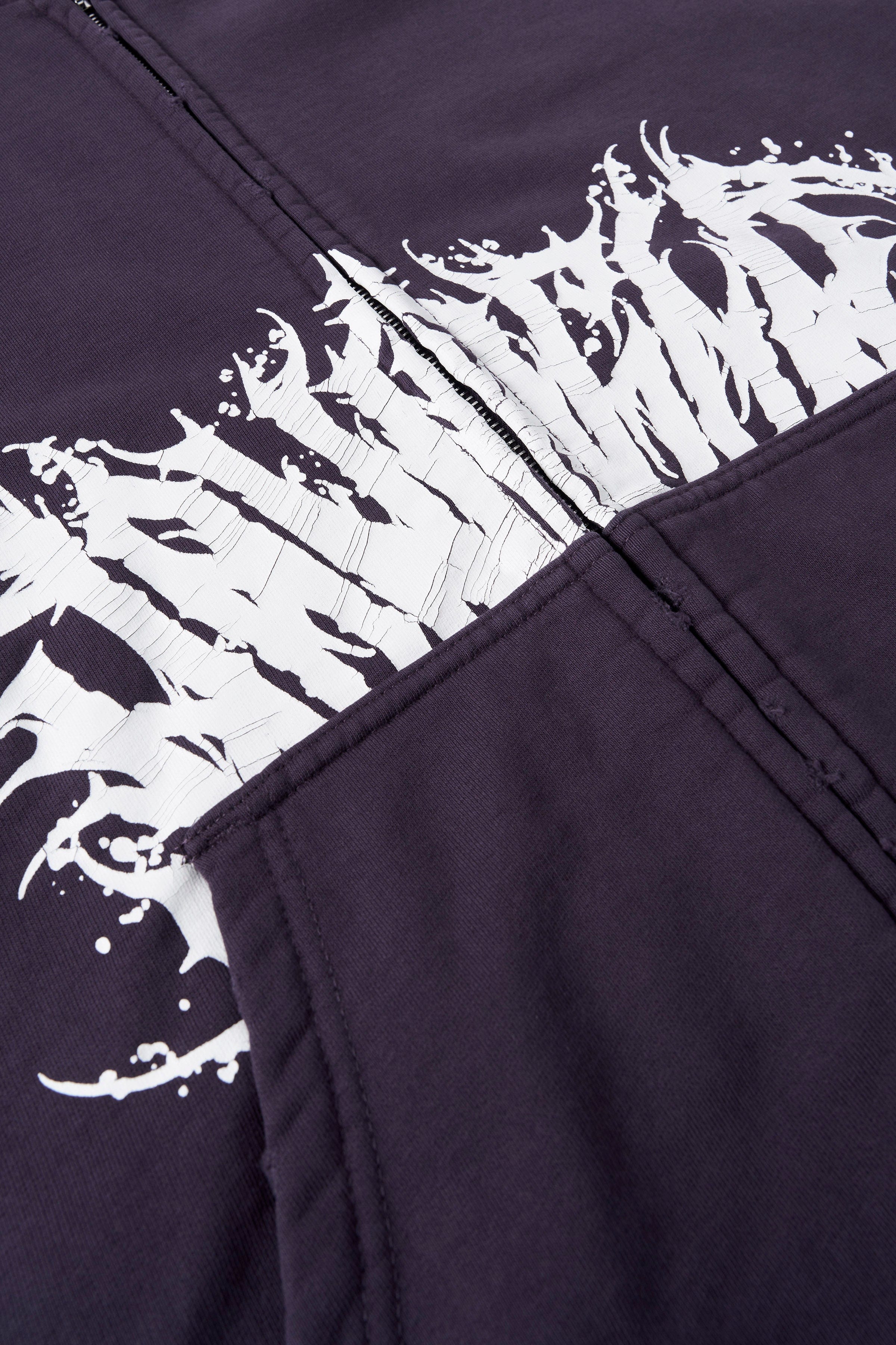 Close-up of tribal graphics on the sleeve of the Venom hoodie, highlighting detailed design and crackle print