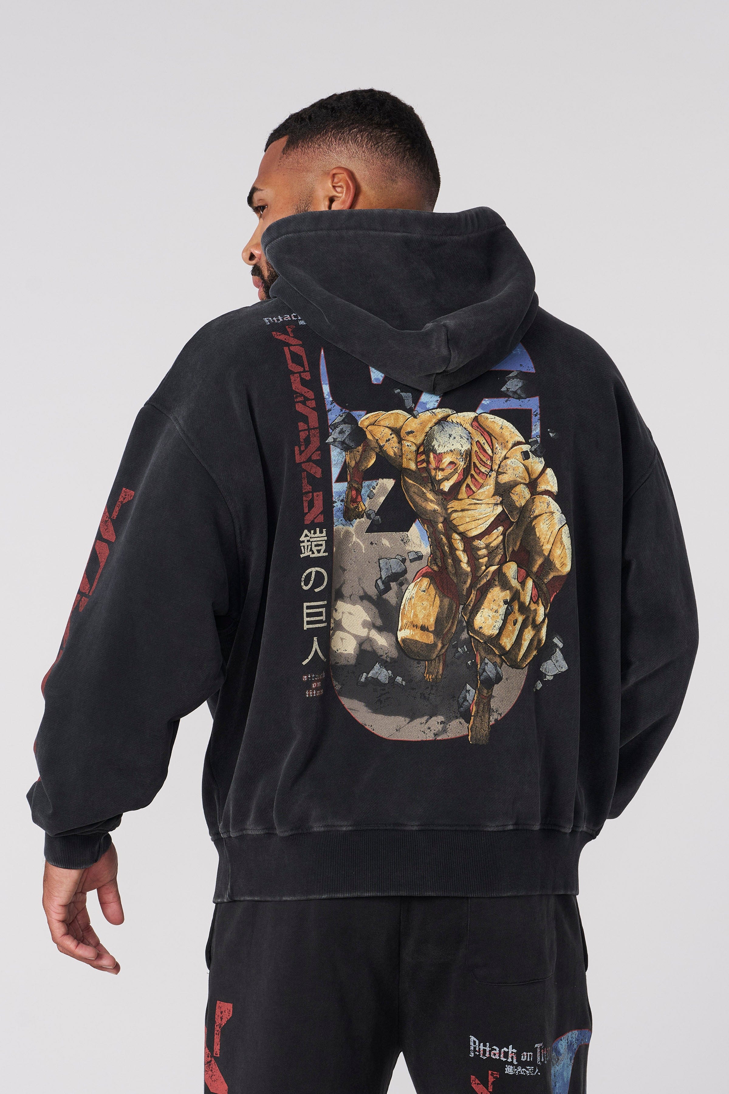 Detailed stitching and print quality of the Attack on Titan merchandise hoodie.
