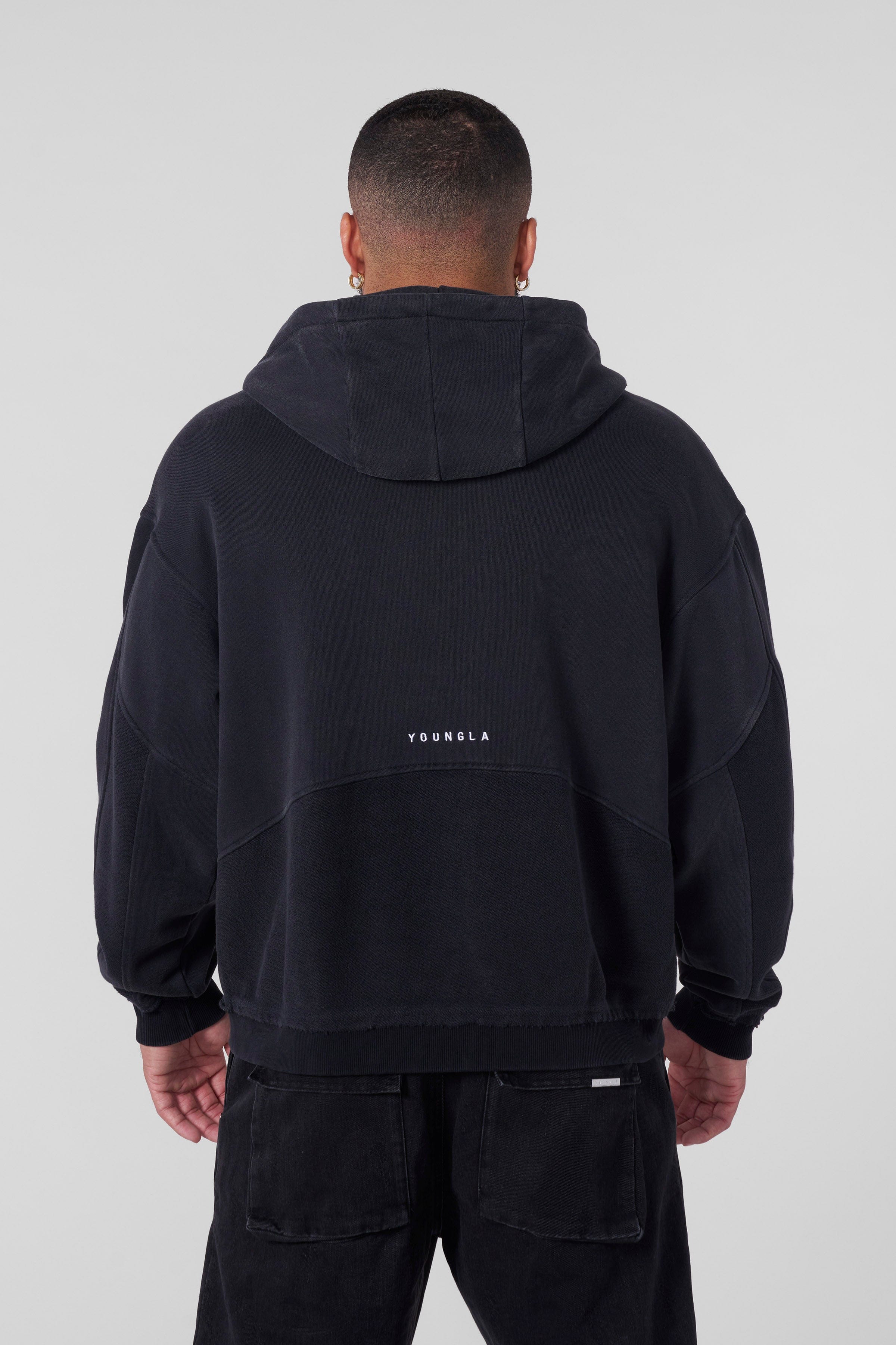 Close-up of the distressed logo on the zip-up hoodie.