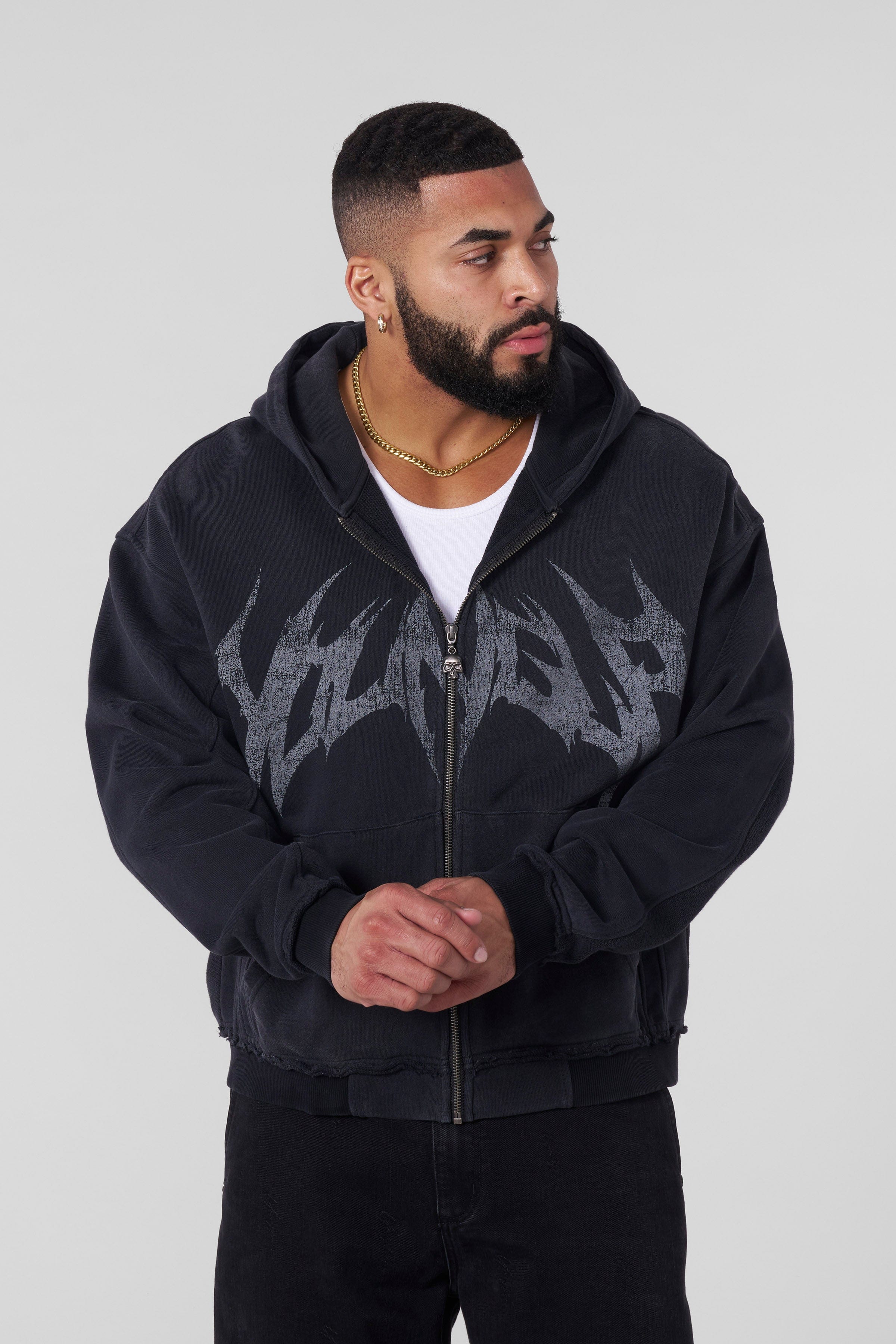 Front view of the distressed black hoodie with skull details.
