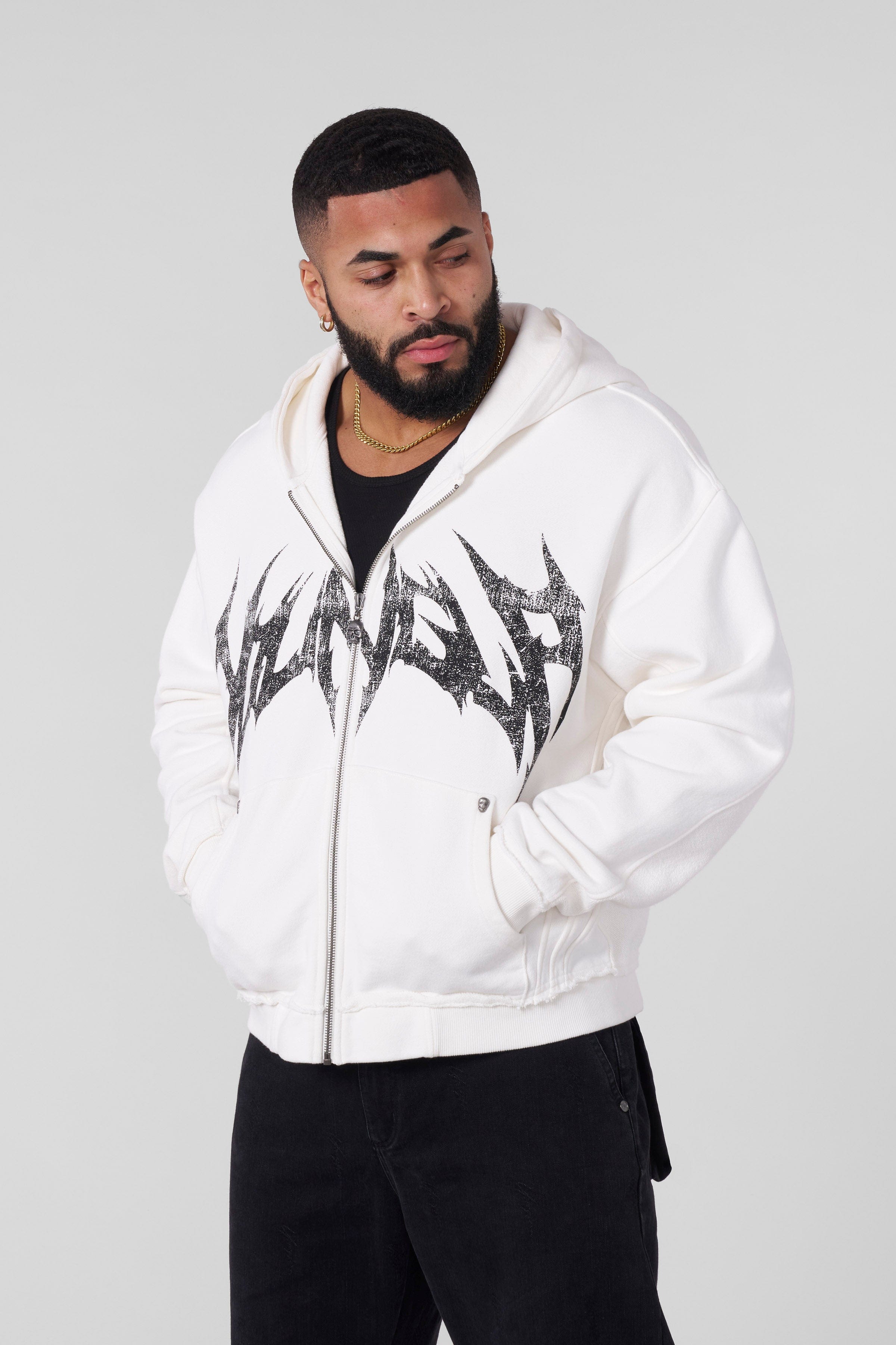 Close-up of the distressed logo on the zip-up hoodie.