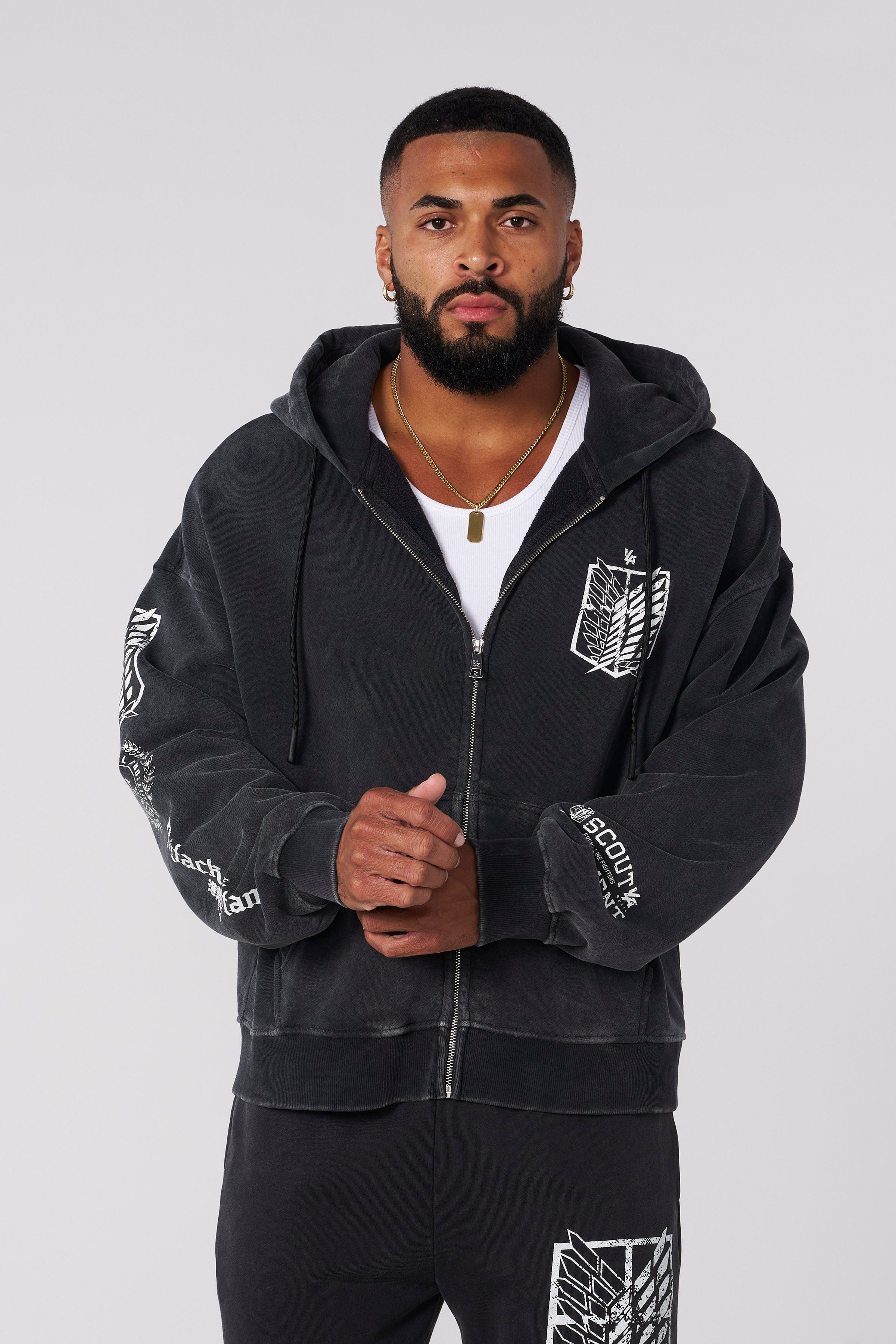 Male model wearing black zip-up hoodie with anime design