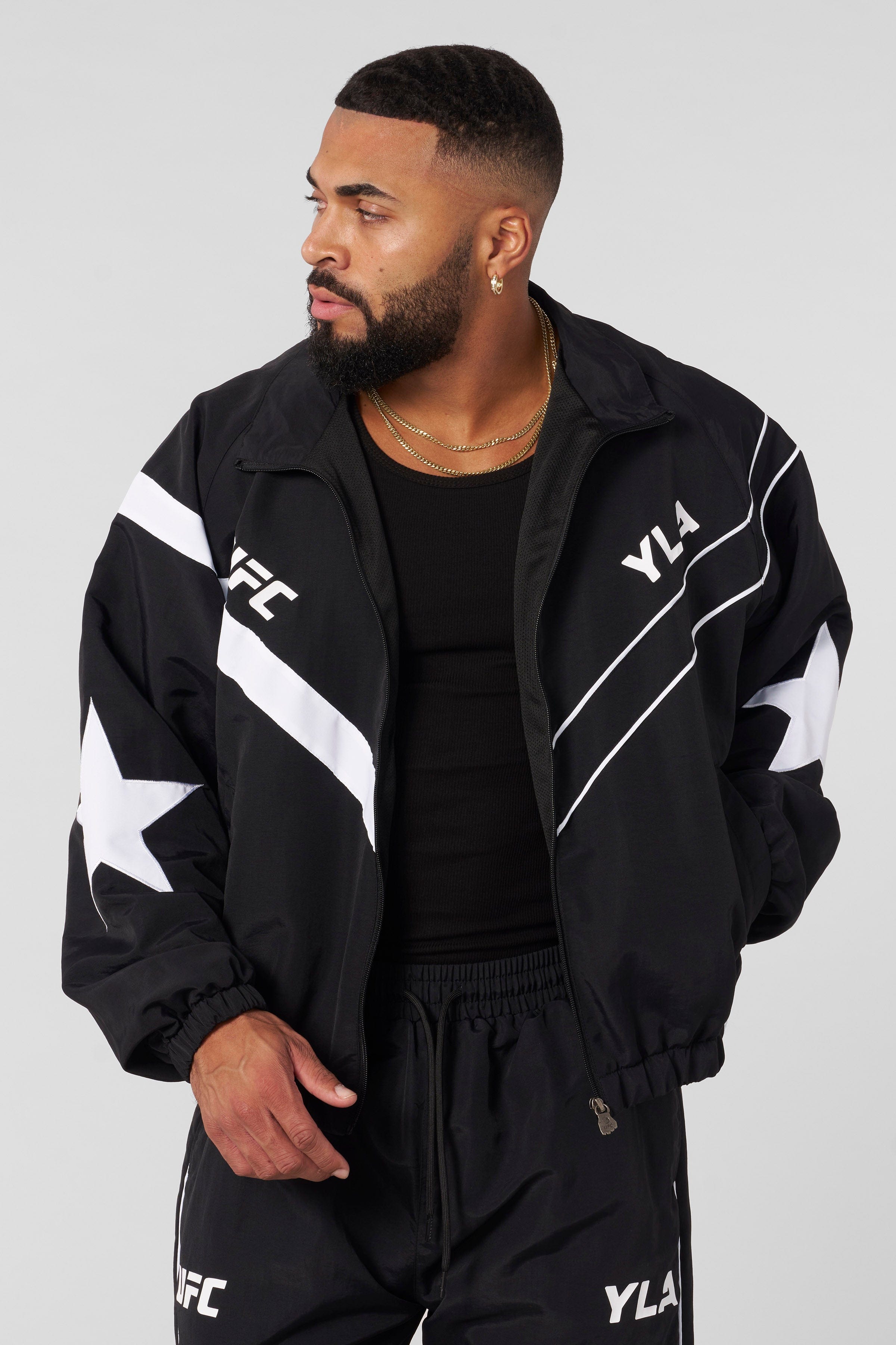 Side view of the mens gray sports jacket, highlighting the star patch and piping details.