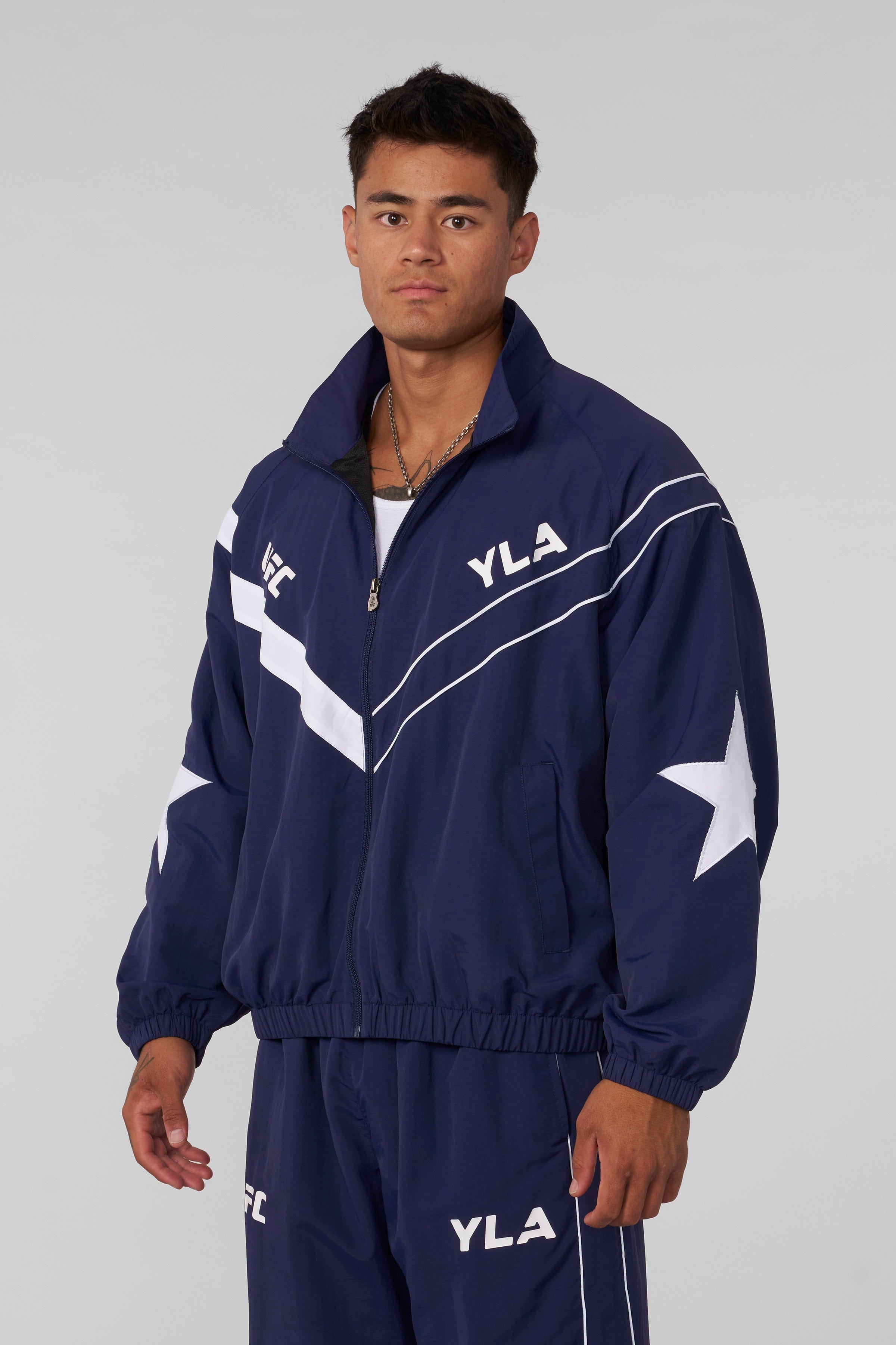 Model wearing the UFC™ tracksuit jacket, perfect for casual outings or gym sessions.