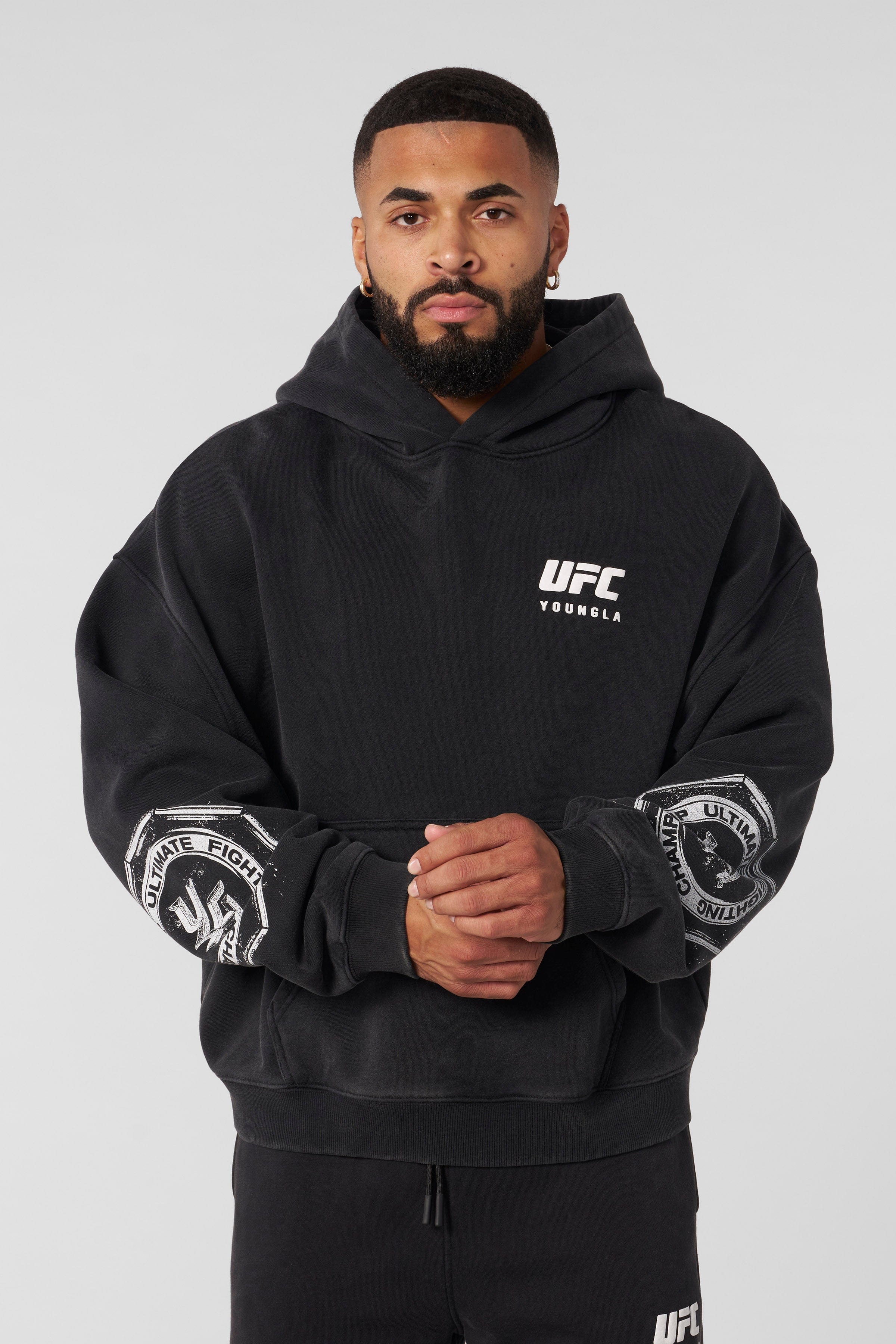 Front view of UFC oversized hoodie showcasing distressed logos.