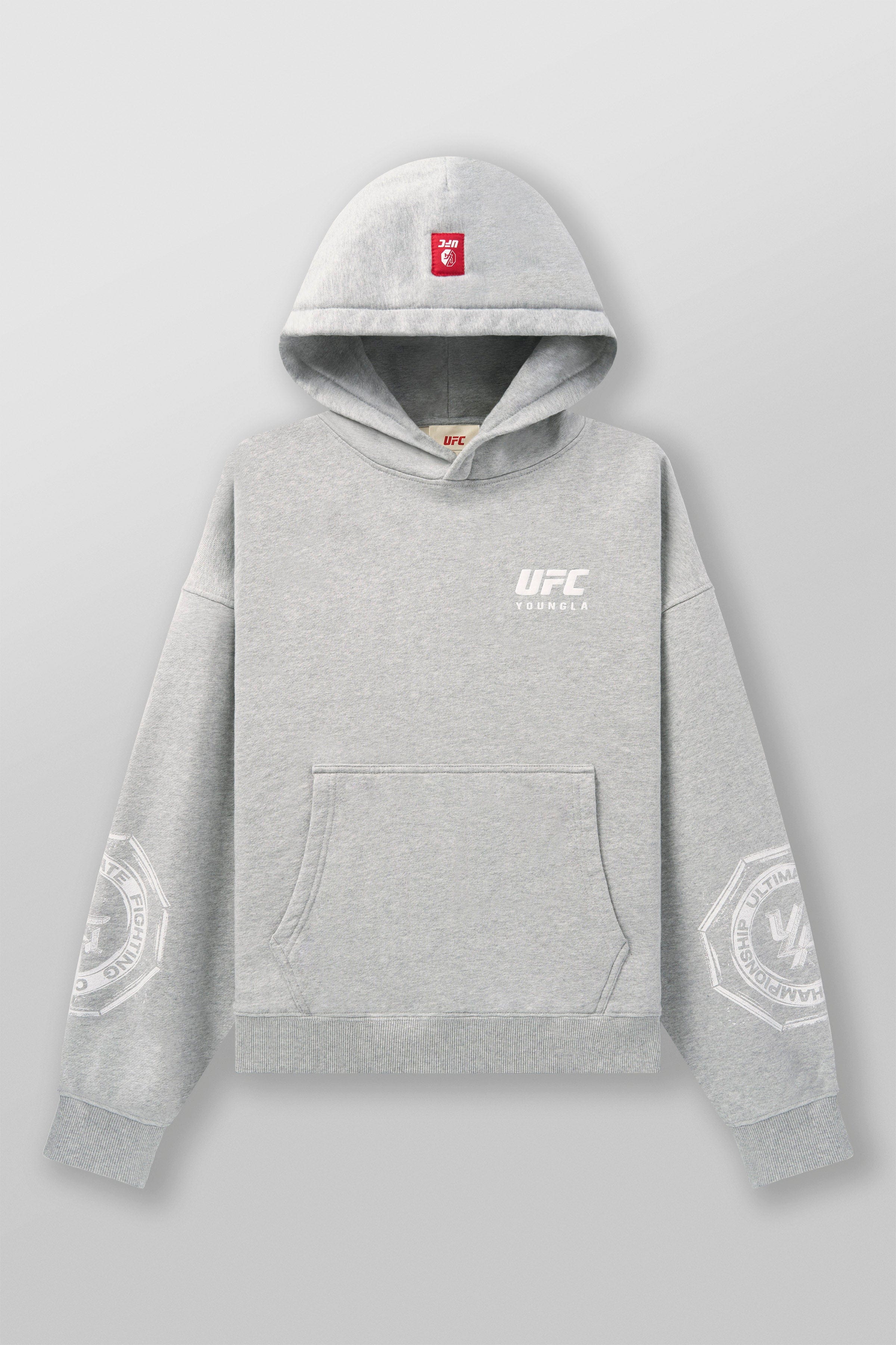 Model wearing the UFC Championship hoodie while lounging.