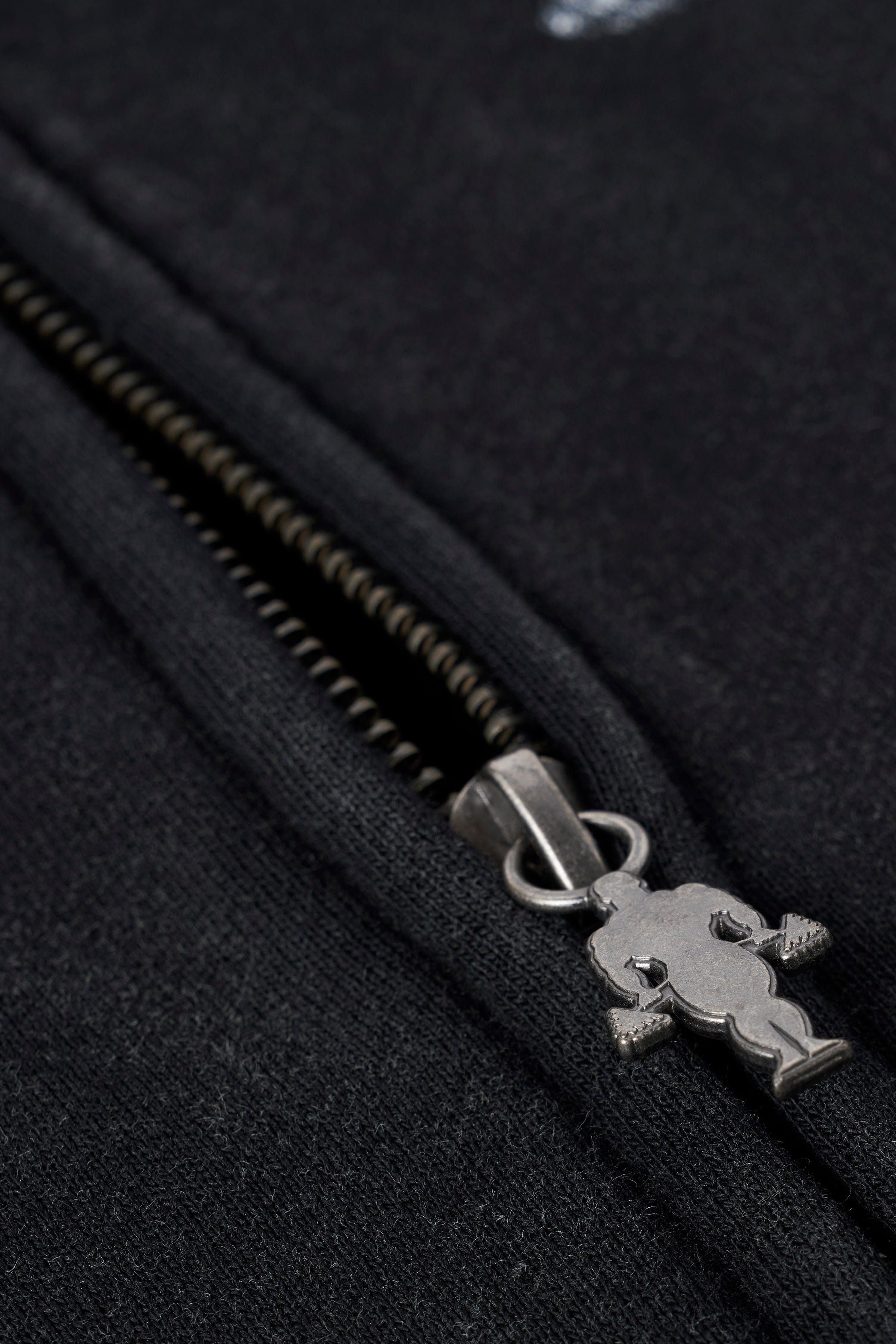Close-up of distressed Golds Gym graphic on hoodie