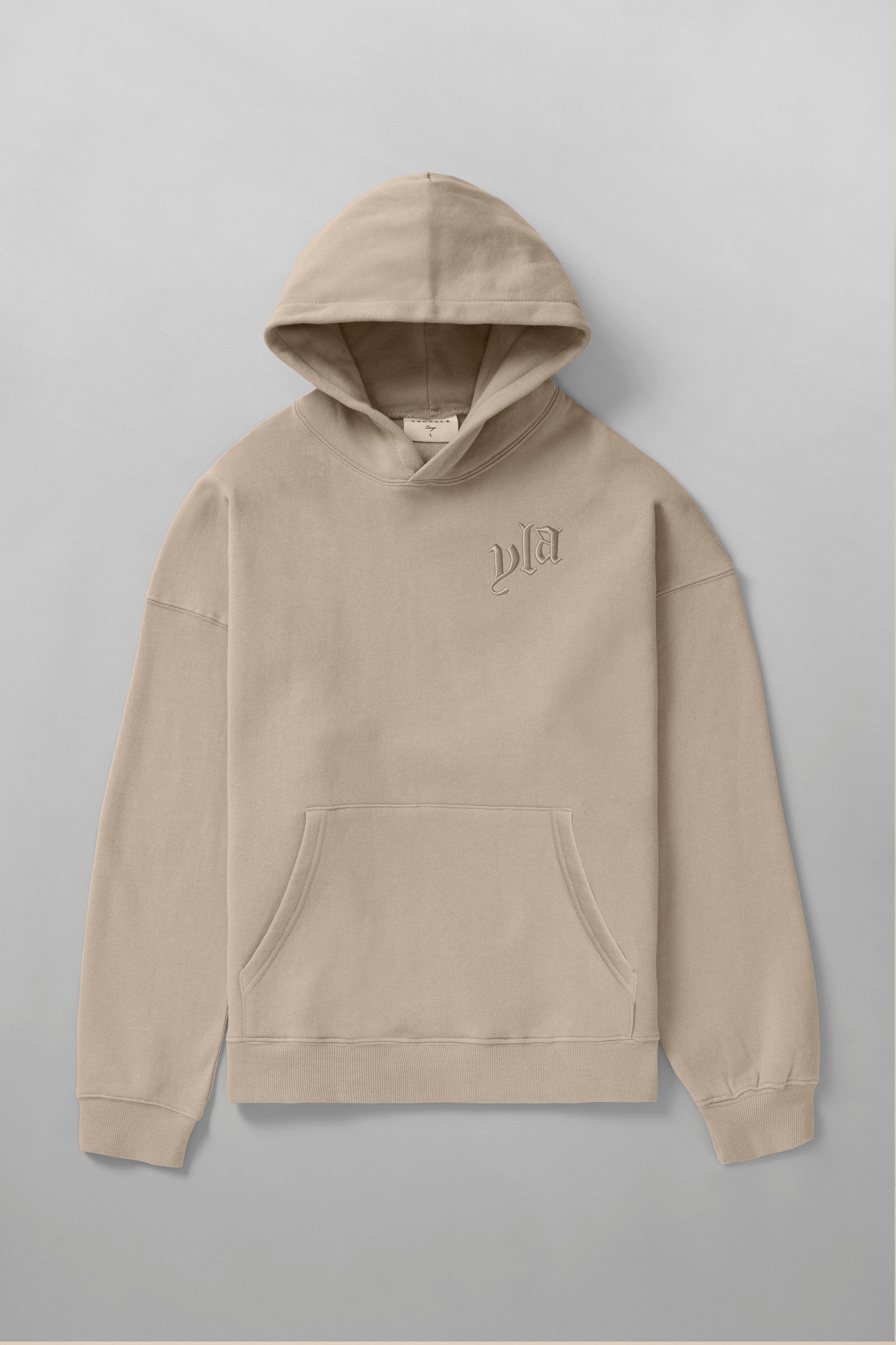 Street-style shot of oversized hoodie with autumn leaves backdrop