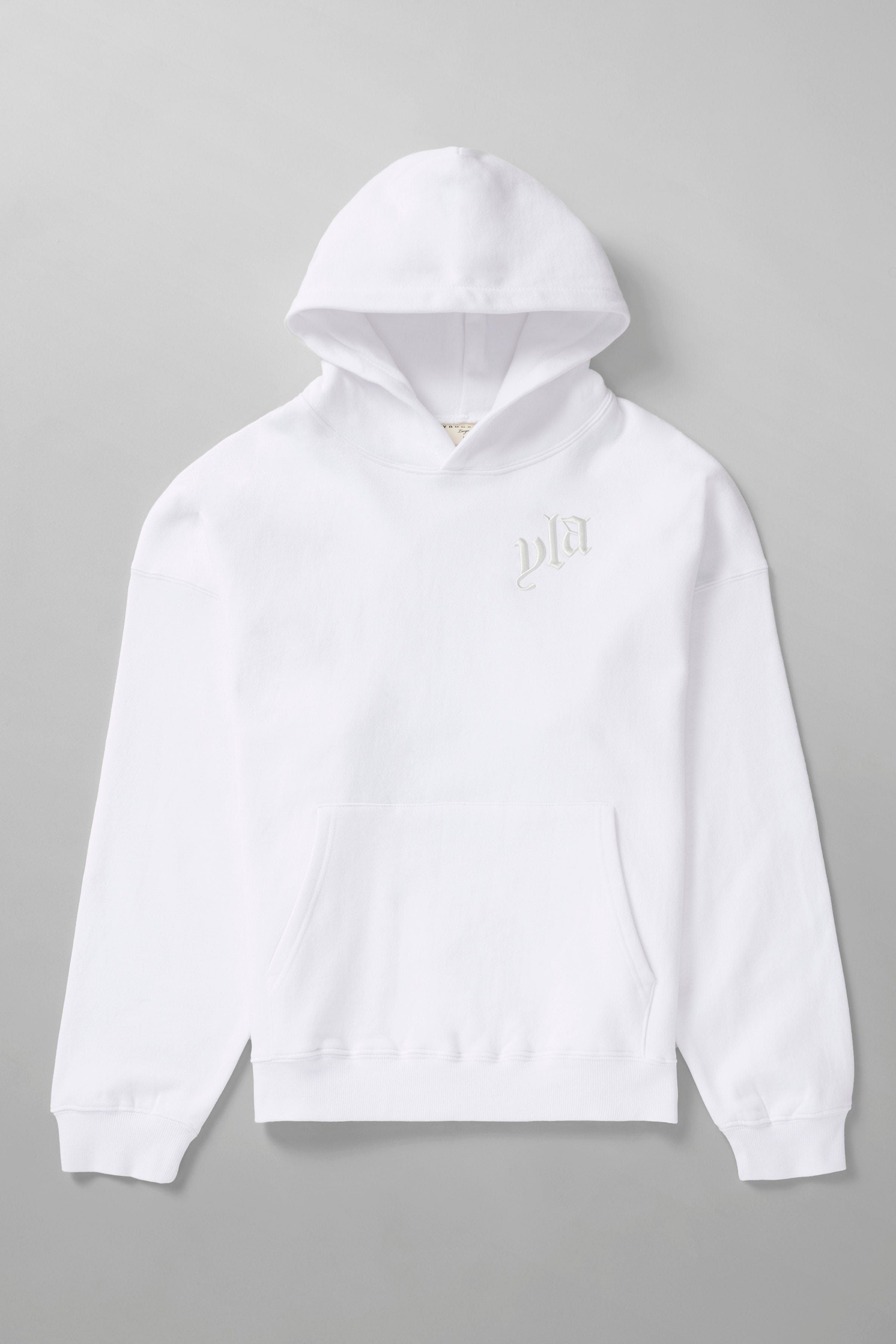 Street-style shot of oversized hoodie with autumn leaves backdrop