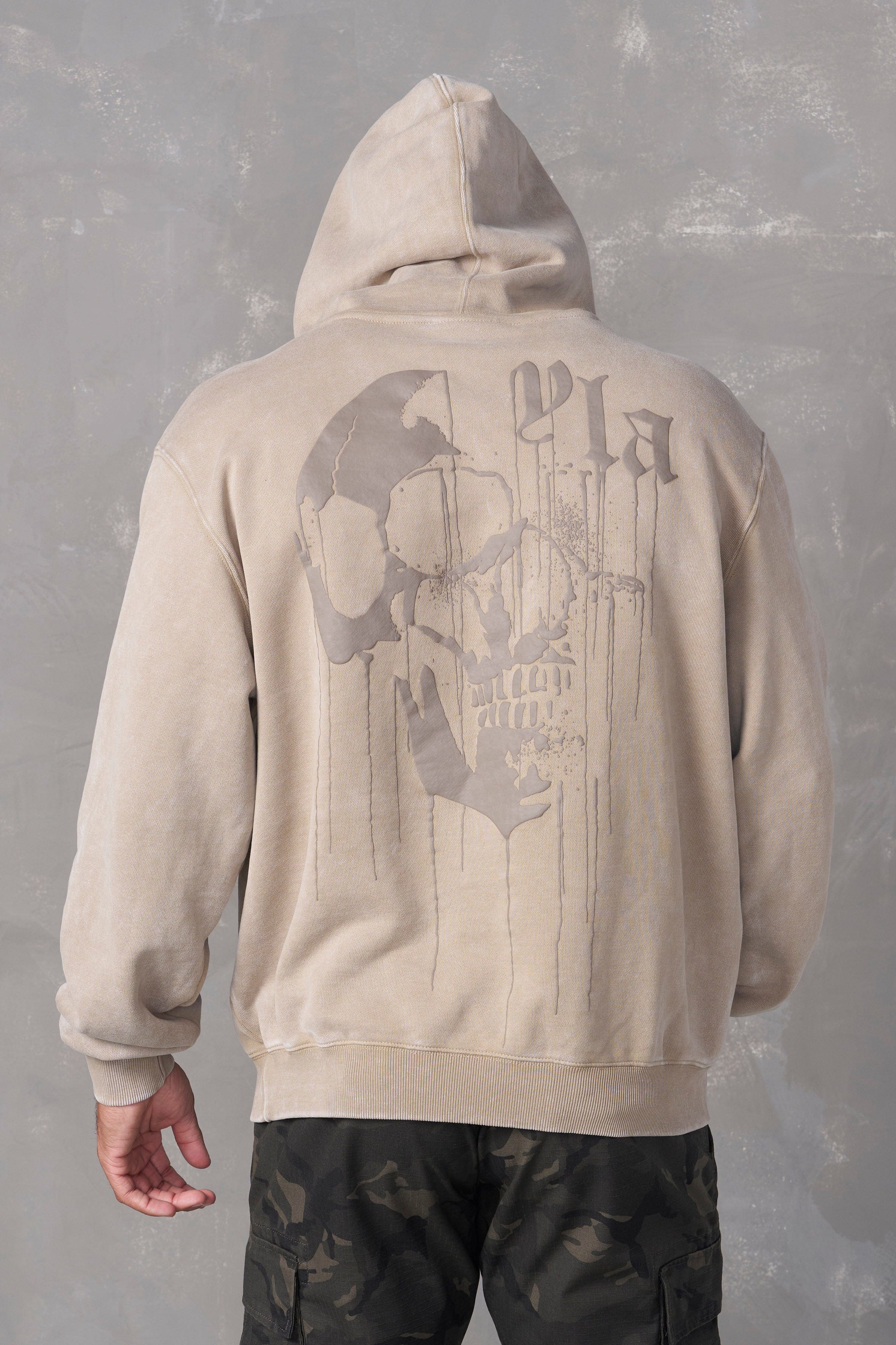 Model wearing the Drippy Skull Hoodie in an urban setting, perfect for street style.