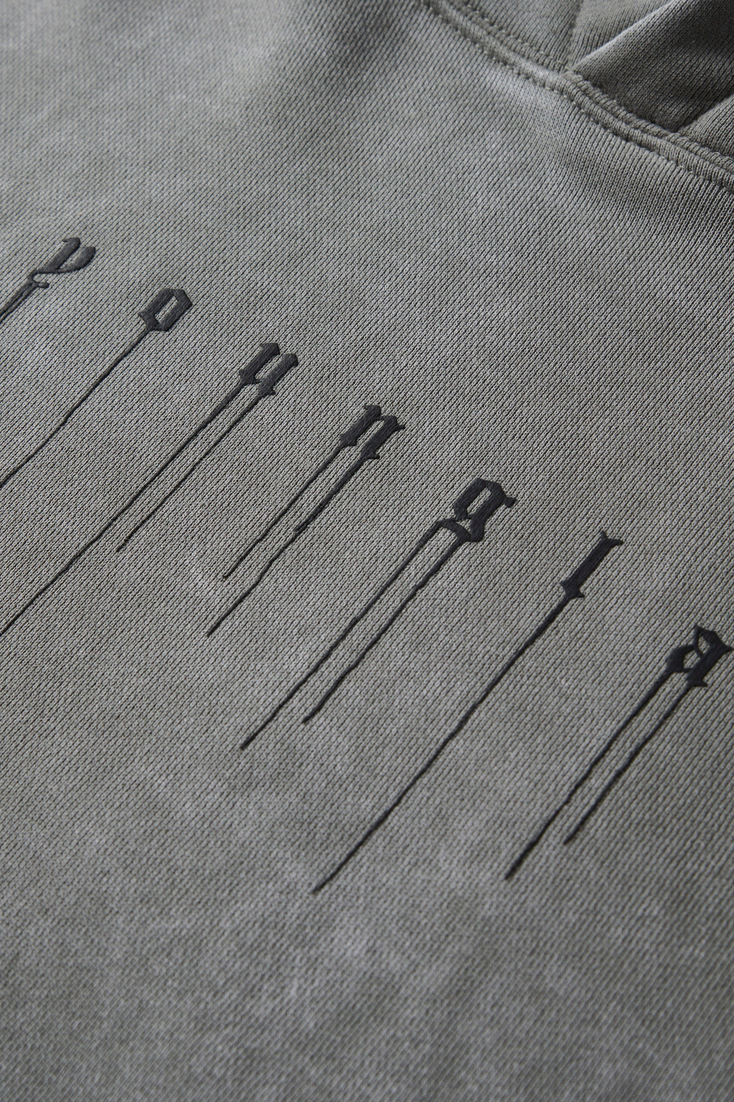 Side angle of the hoodie demonstrating its fit and washed vintage finish.
