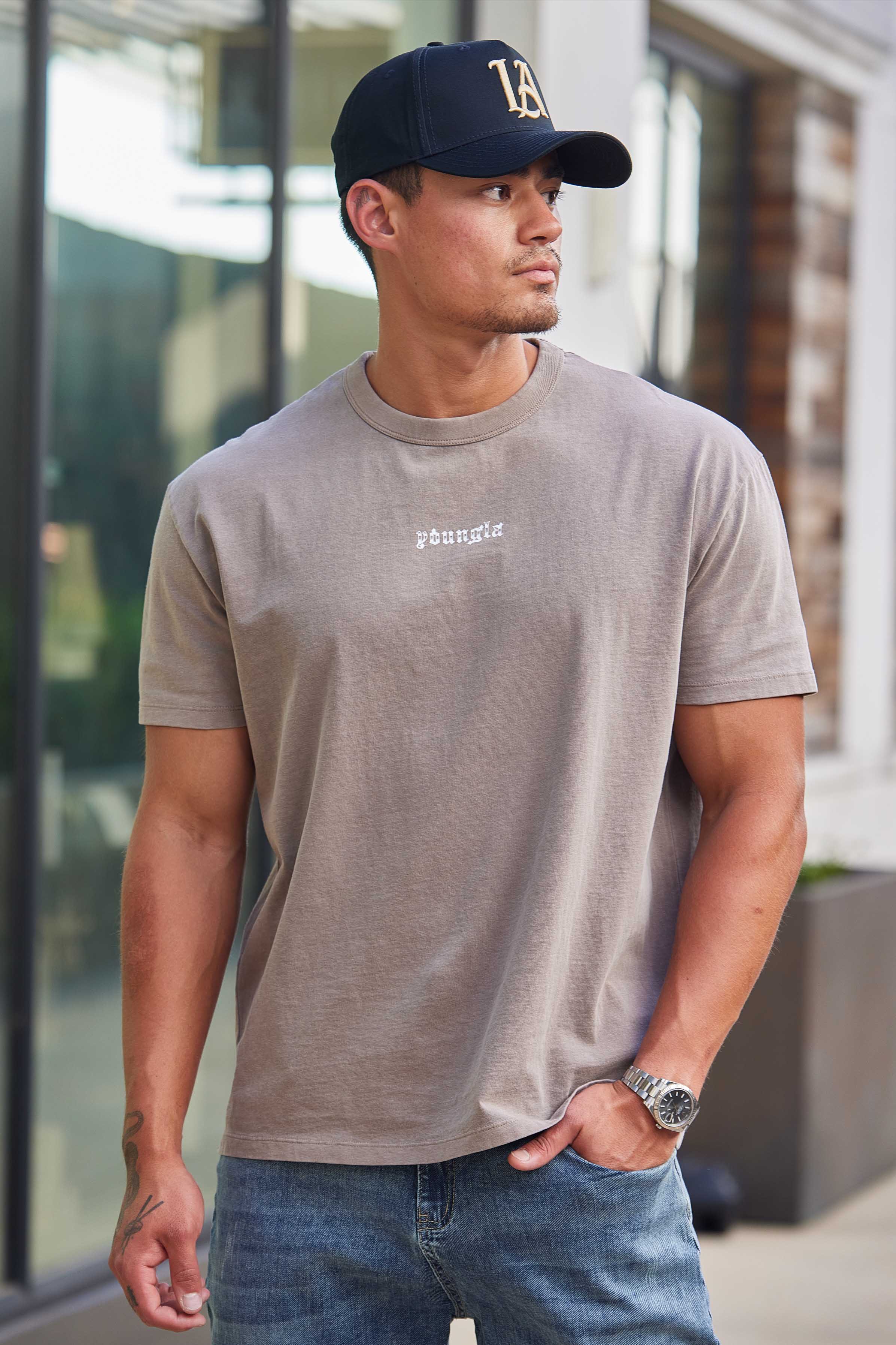 Close-up shot of the embroidered hats crown and adjustable snap closure, styled for men.