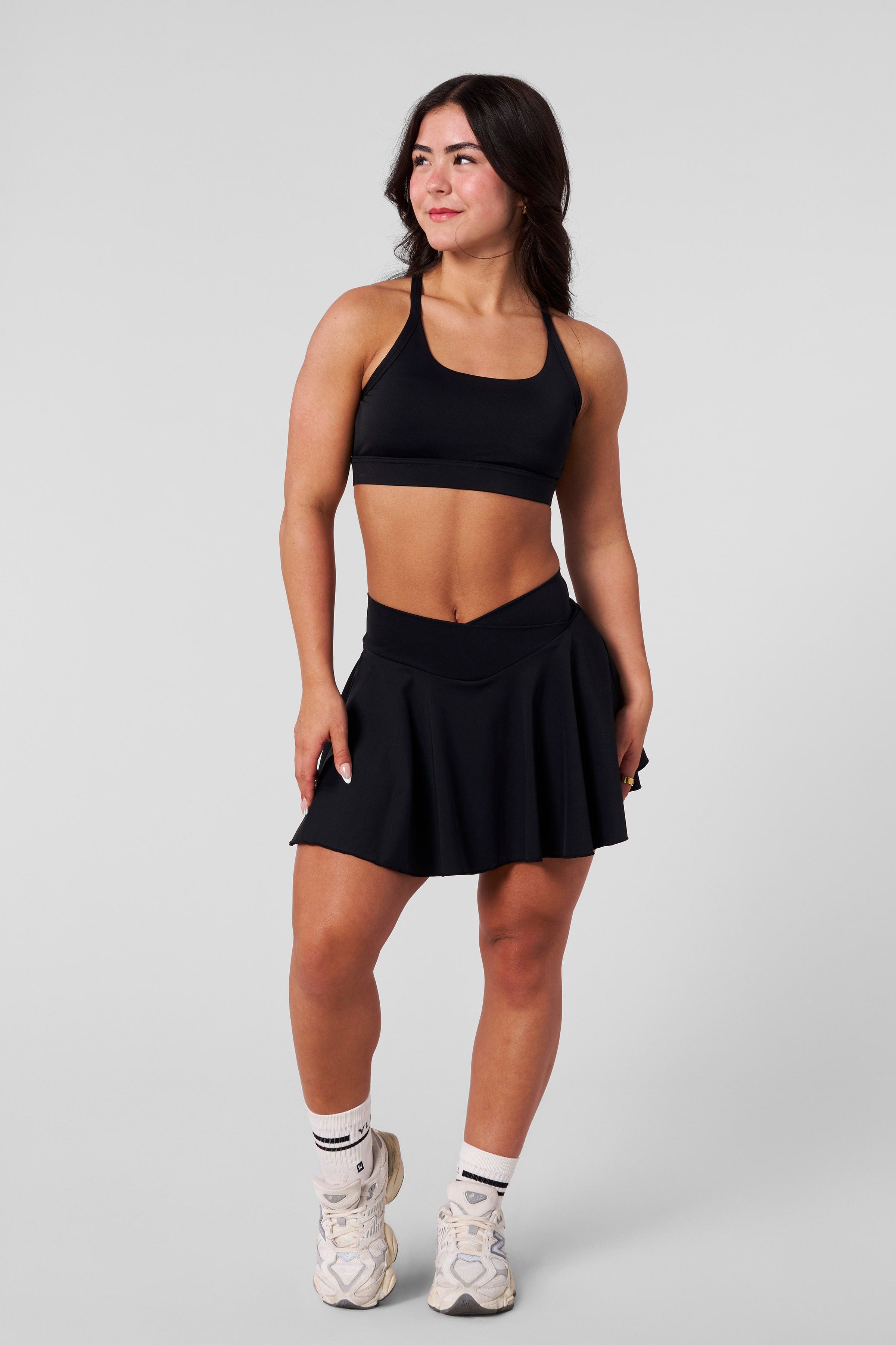 Front view of the Nova active tennis skirt on a woman during a game