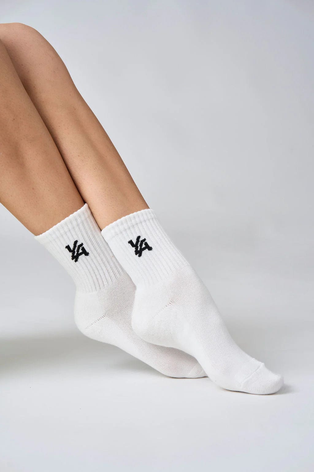 Model wearing comfortable cotton crew socks in casual setting.