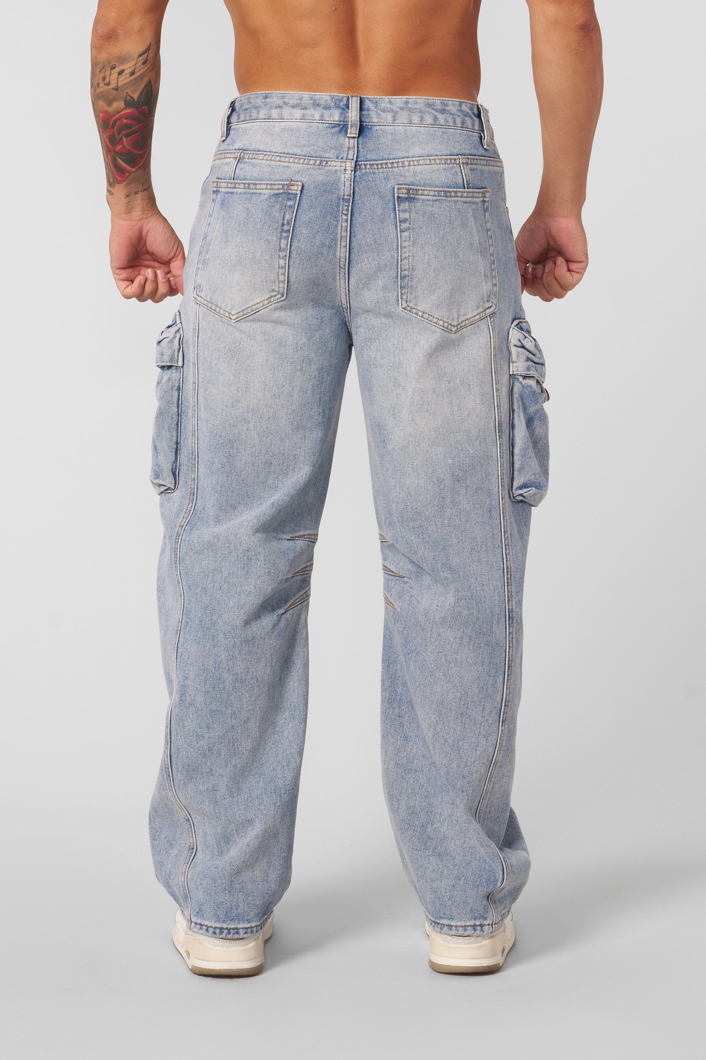 Close-up of fabric texture and fading on baggy cargo jeans for men