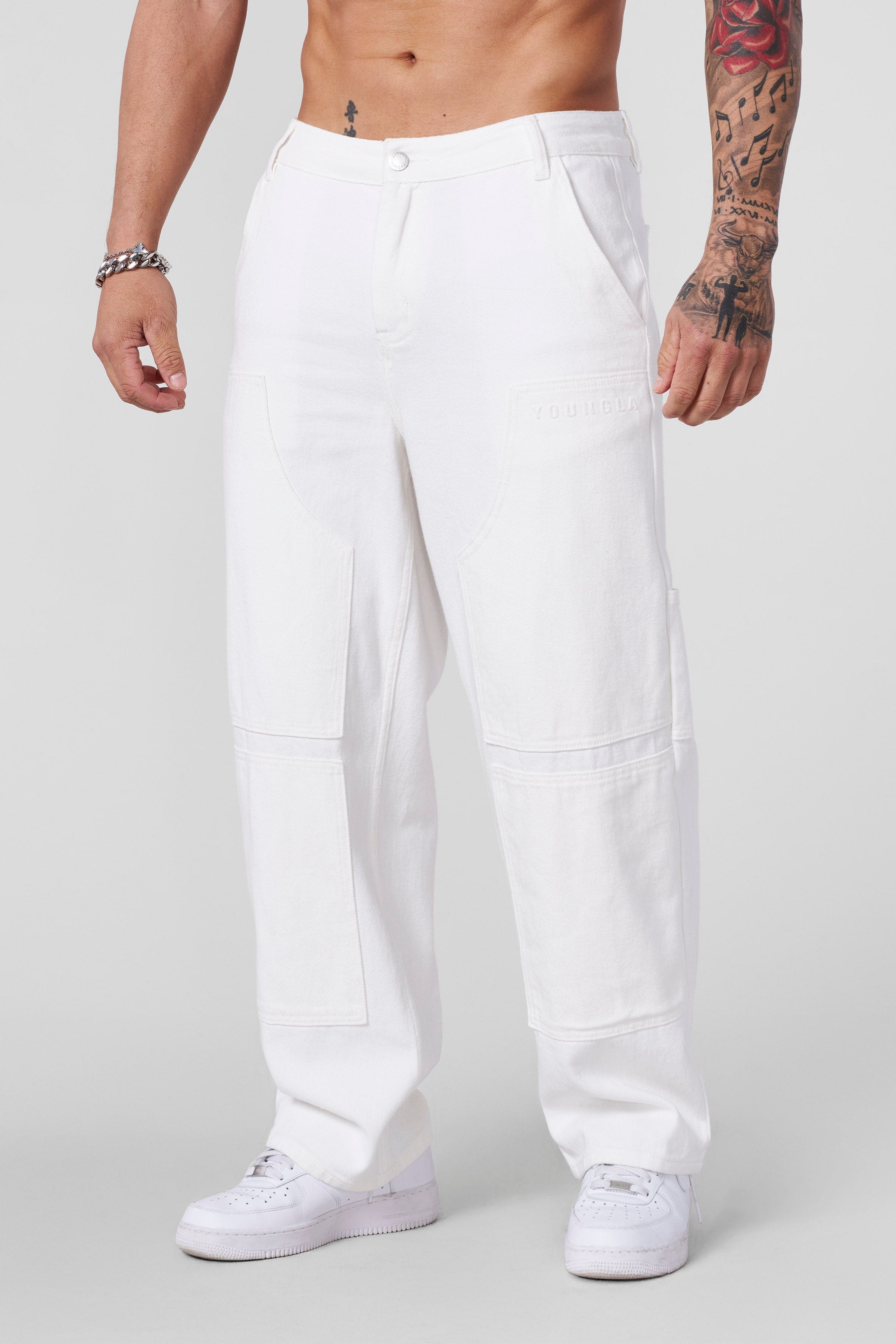 Close-up of baggy black jeans with reinforced stitching.