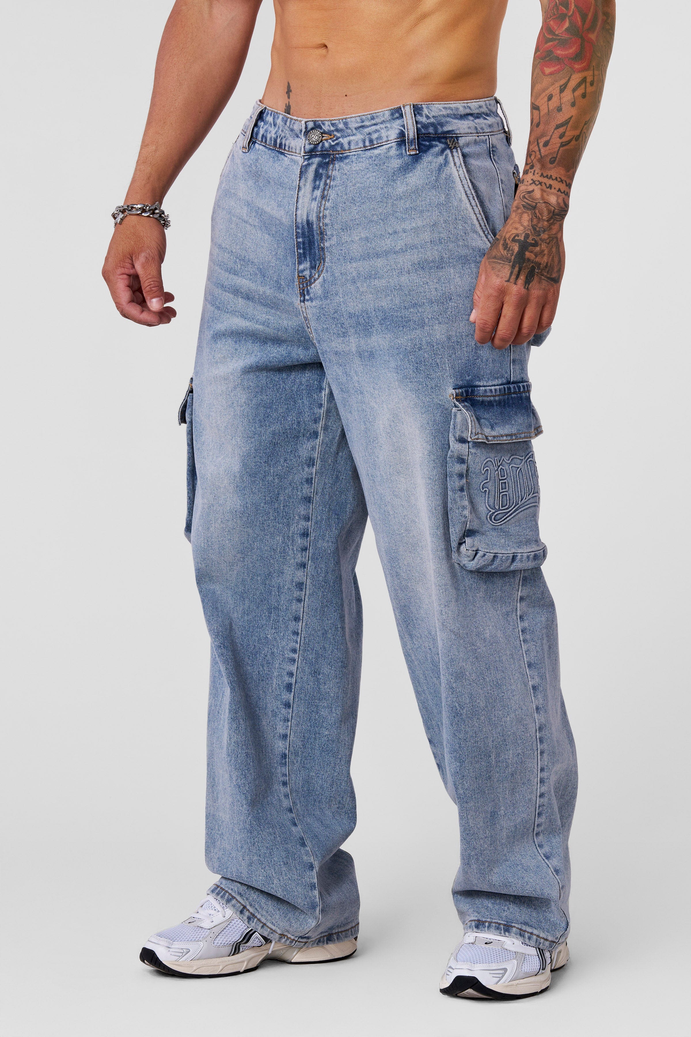 Close-up of sand-washed denim texture on cargo jeans