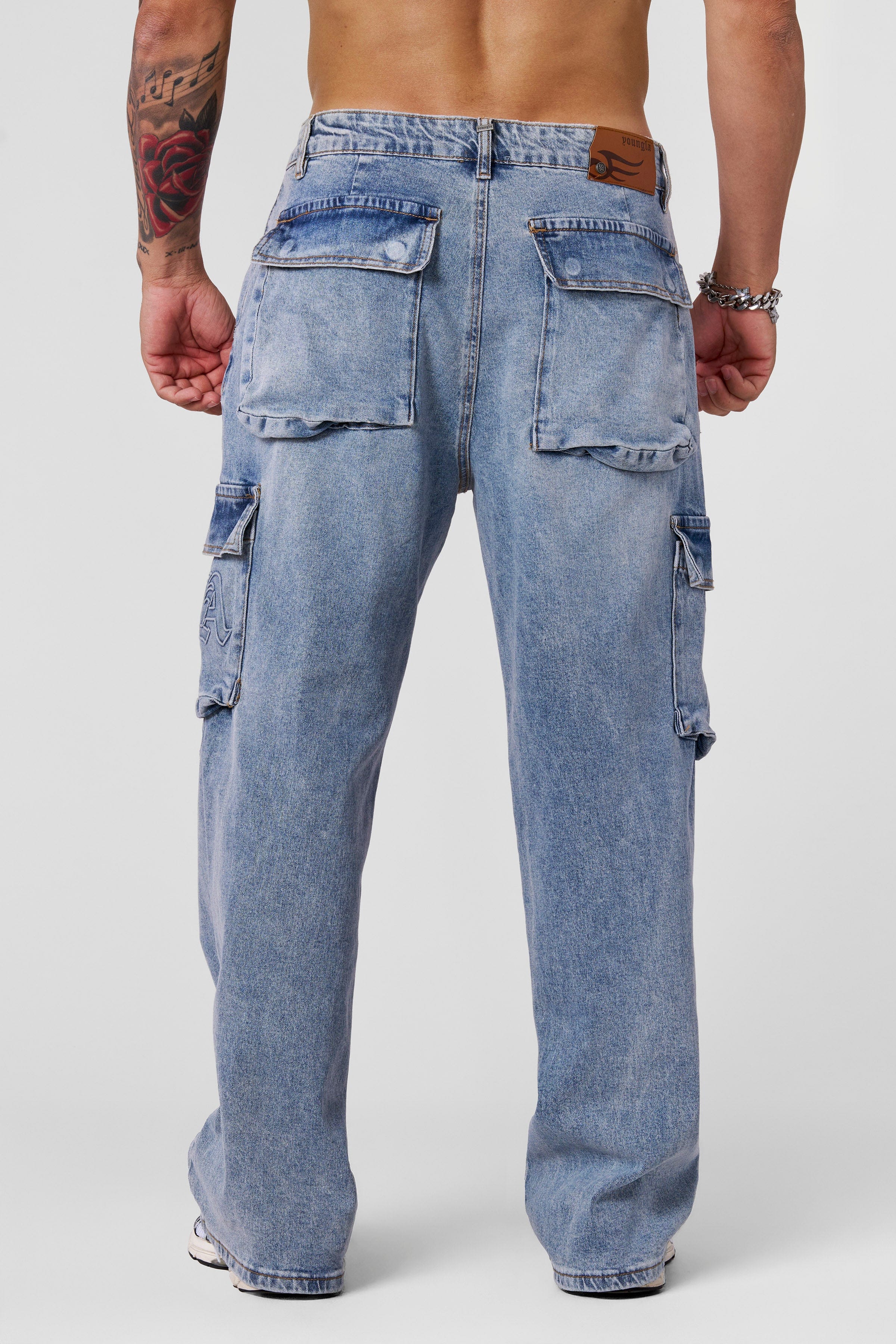 Close-up of sand-washed denim texture on cargo jeans