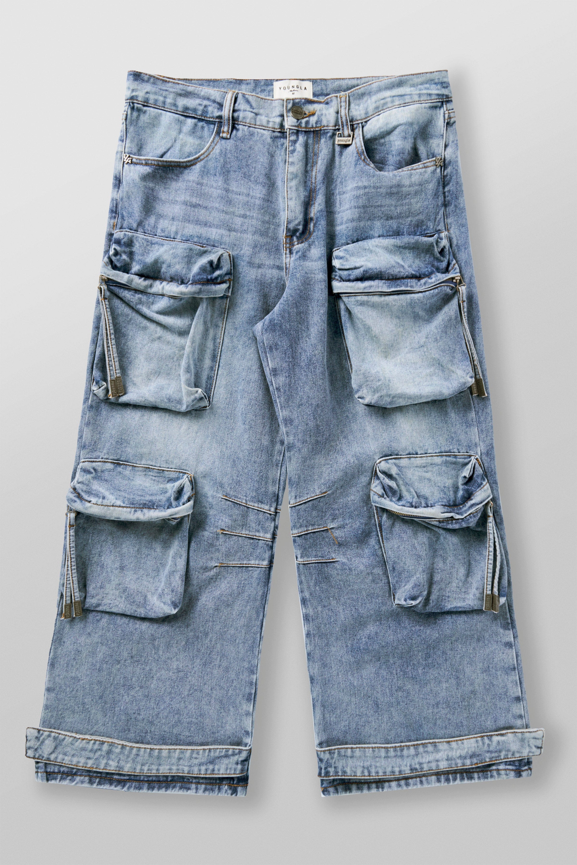 Close-up detail of worn-in fabric texture and functional pocket design on low rise jeans