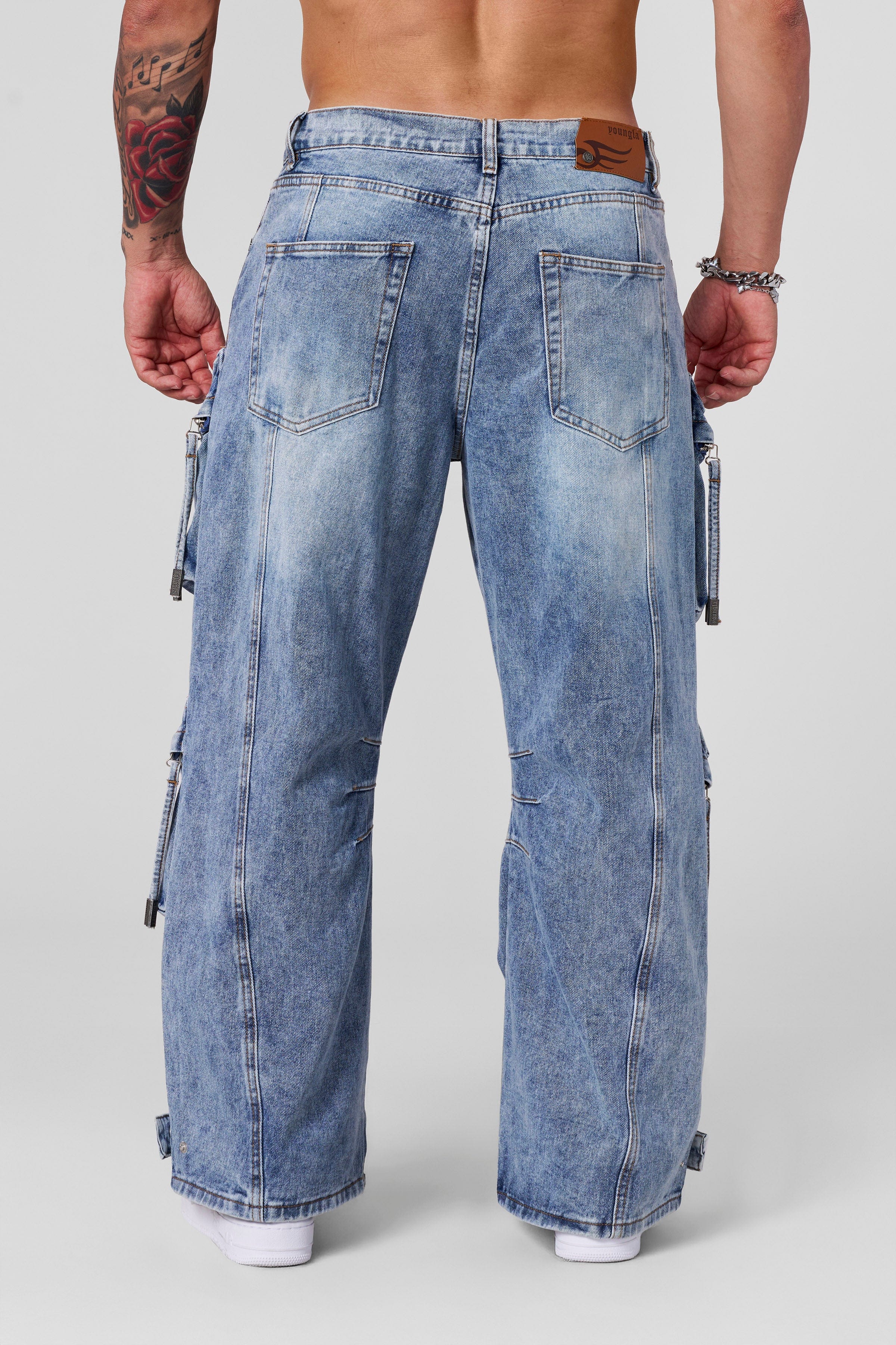 Close-up detail of worn-in fabric texture and functional pocket design on low rise jeans