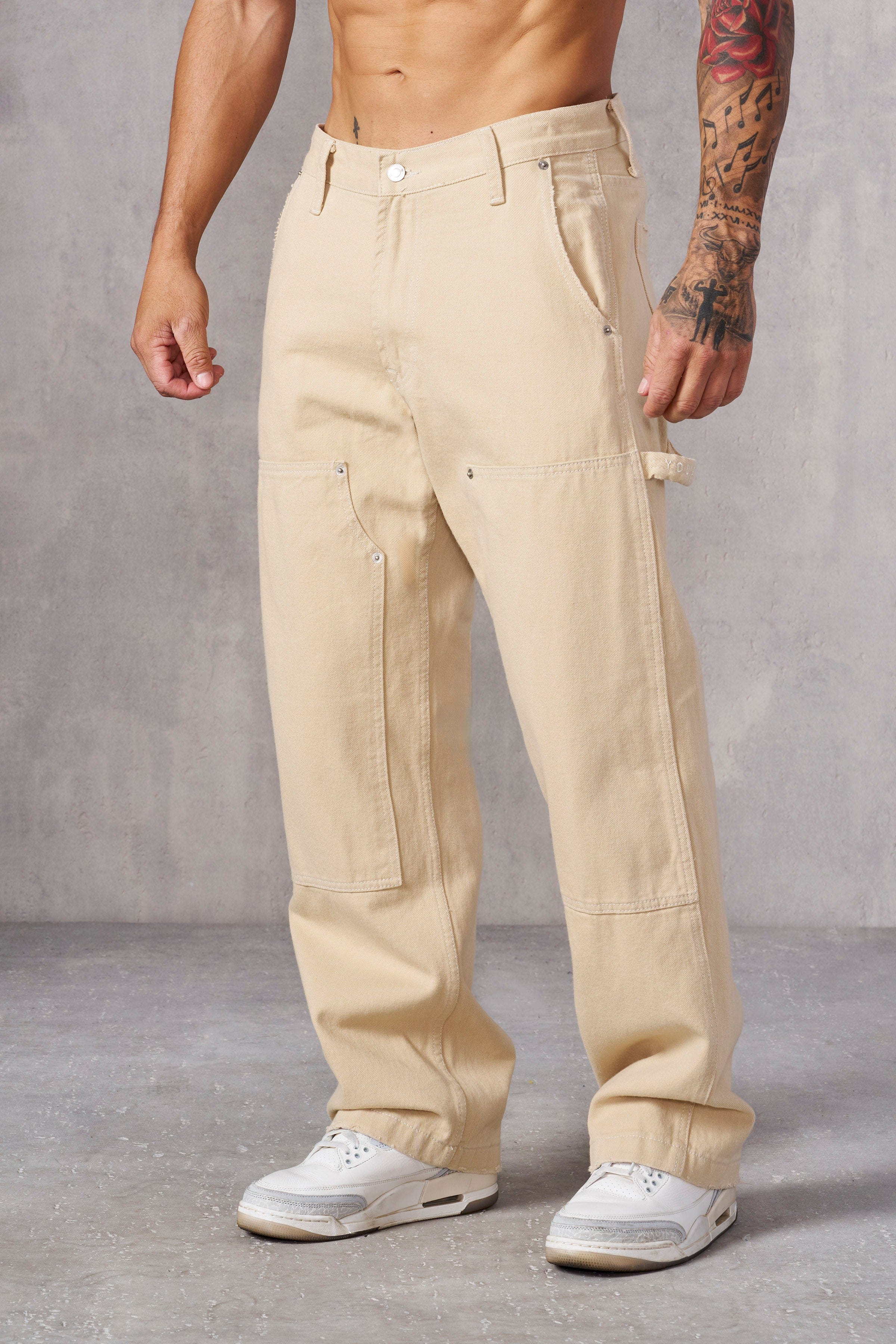 Front view of rugged carpenter jeans for men in blue wash.