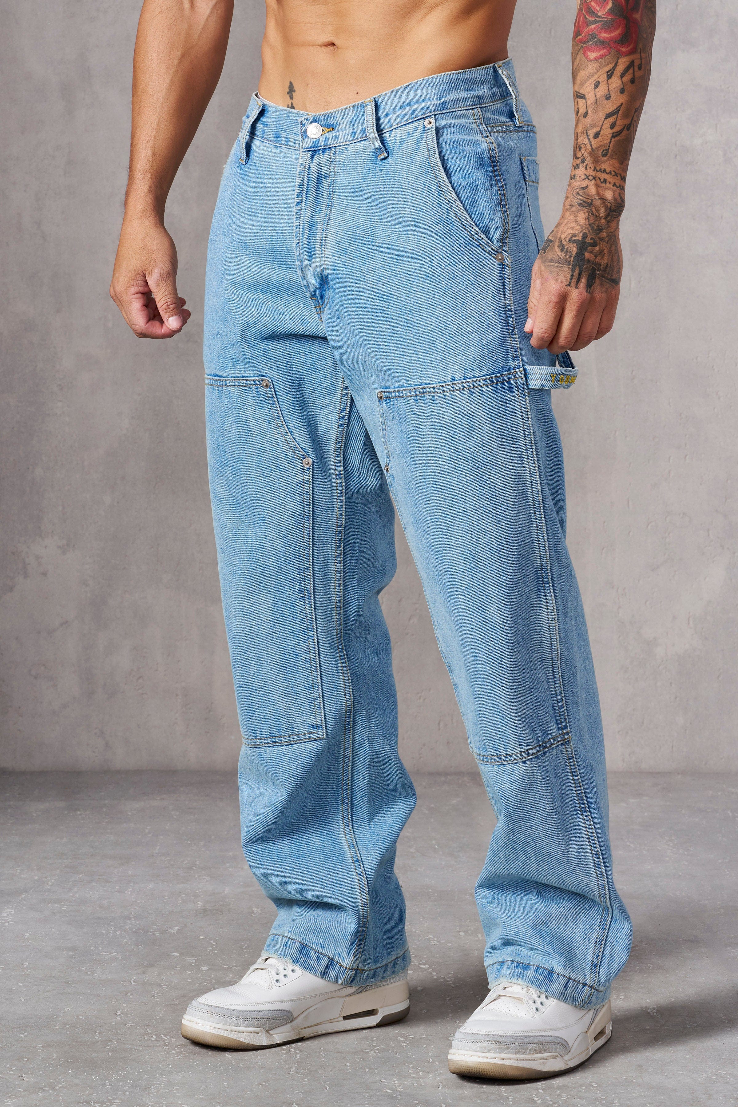 Front view of rugged carpenter jeans for men in blue wash.