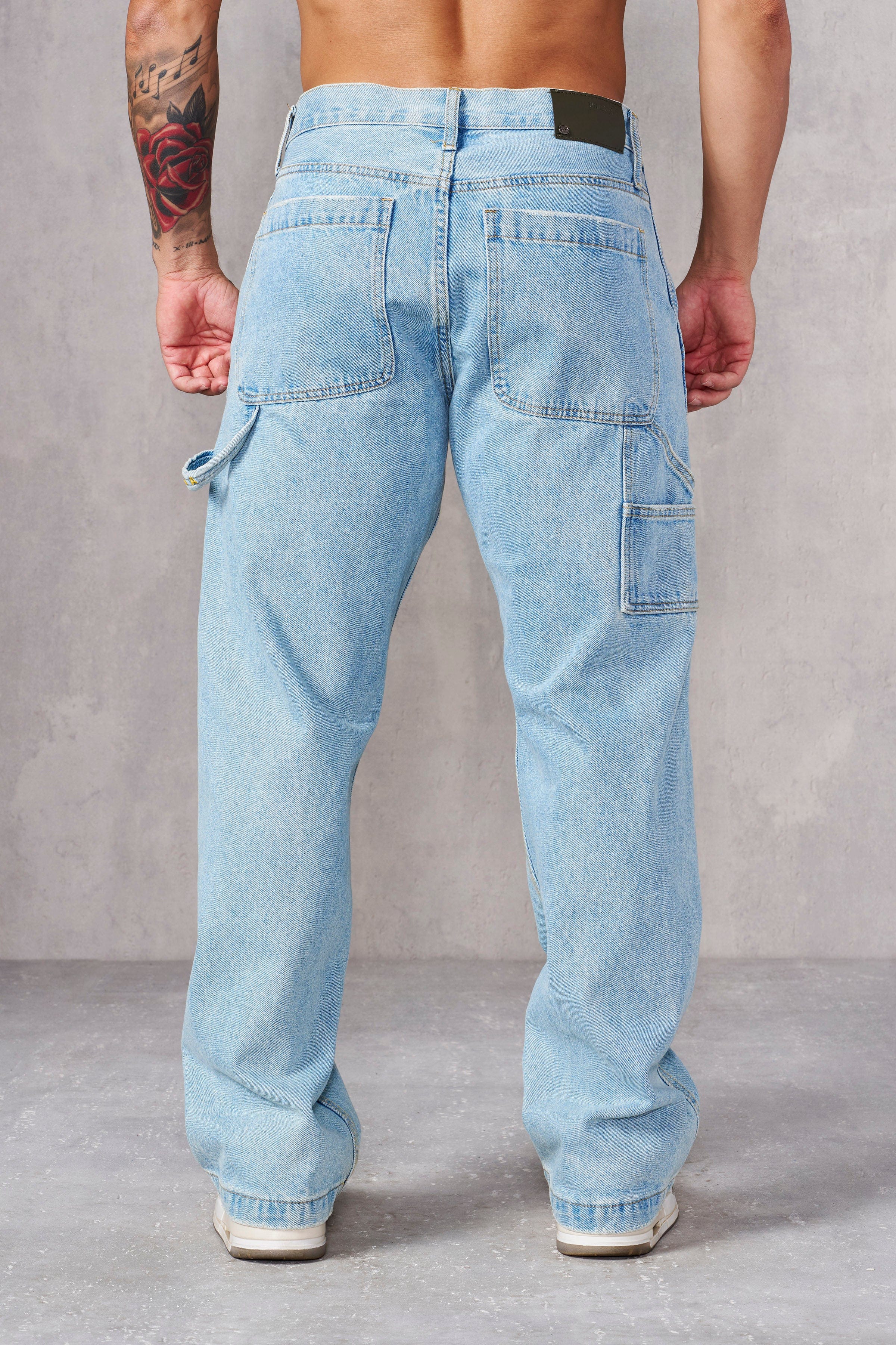 Model wearing rugged carpenter jeans, ideal for work and casual outings.