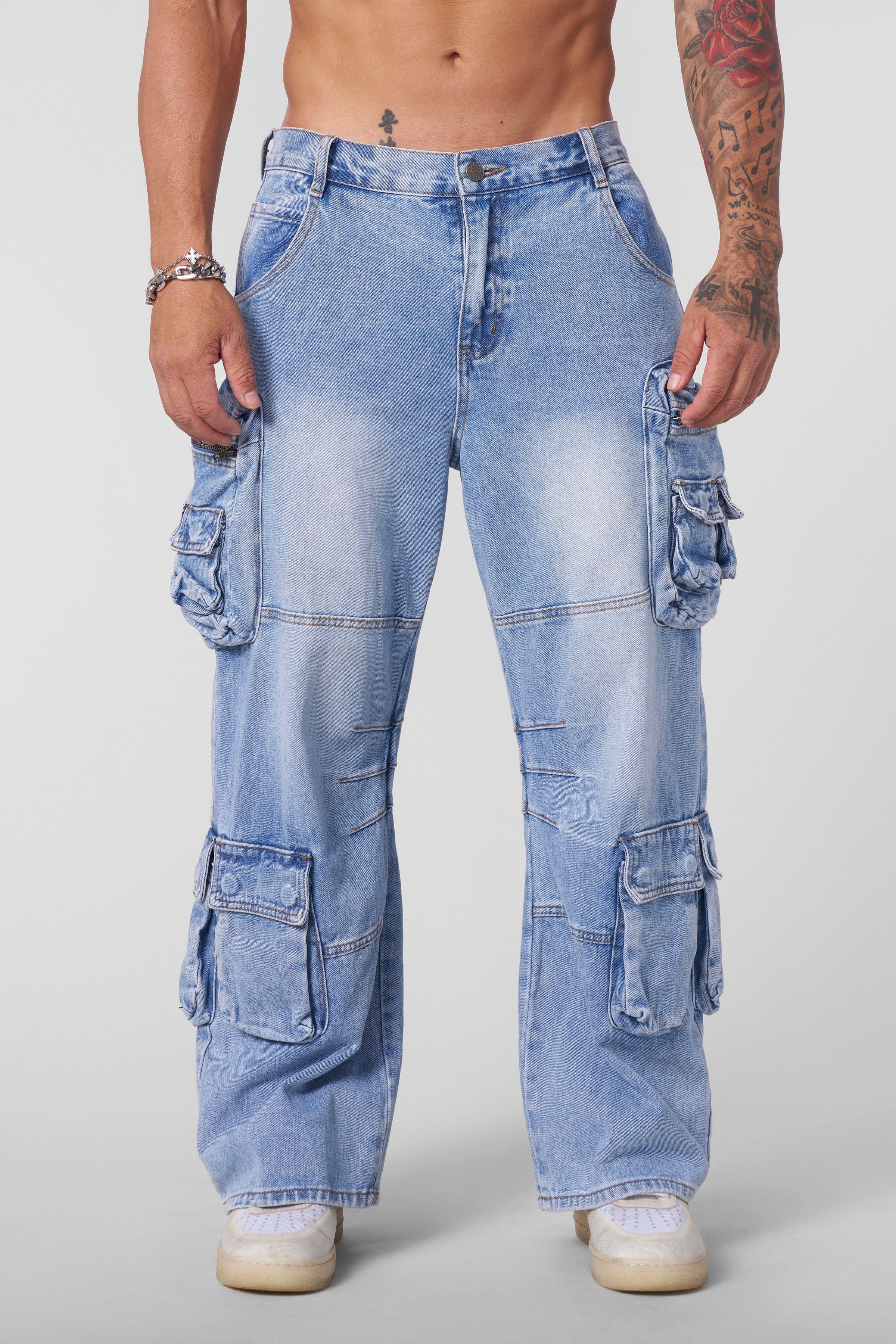 Close-up of the cargo pockets on stylish stacked jeans for men.