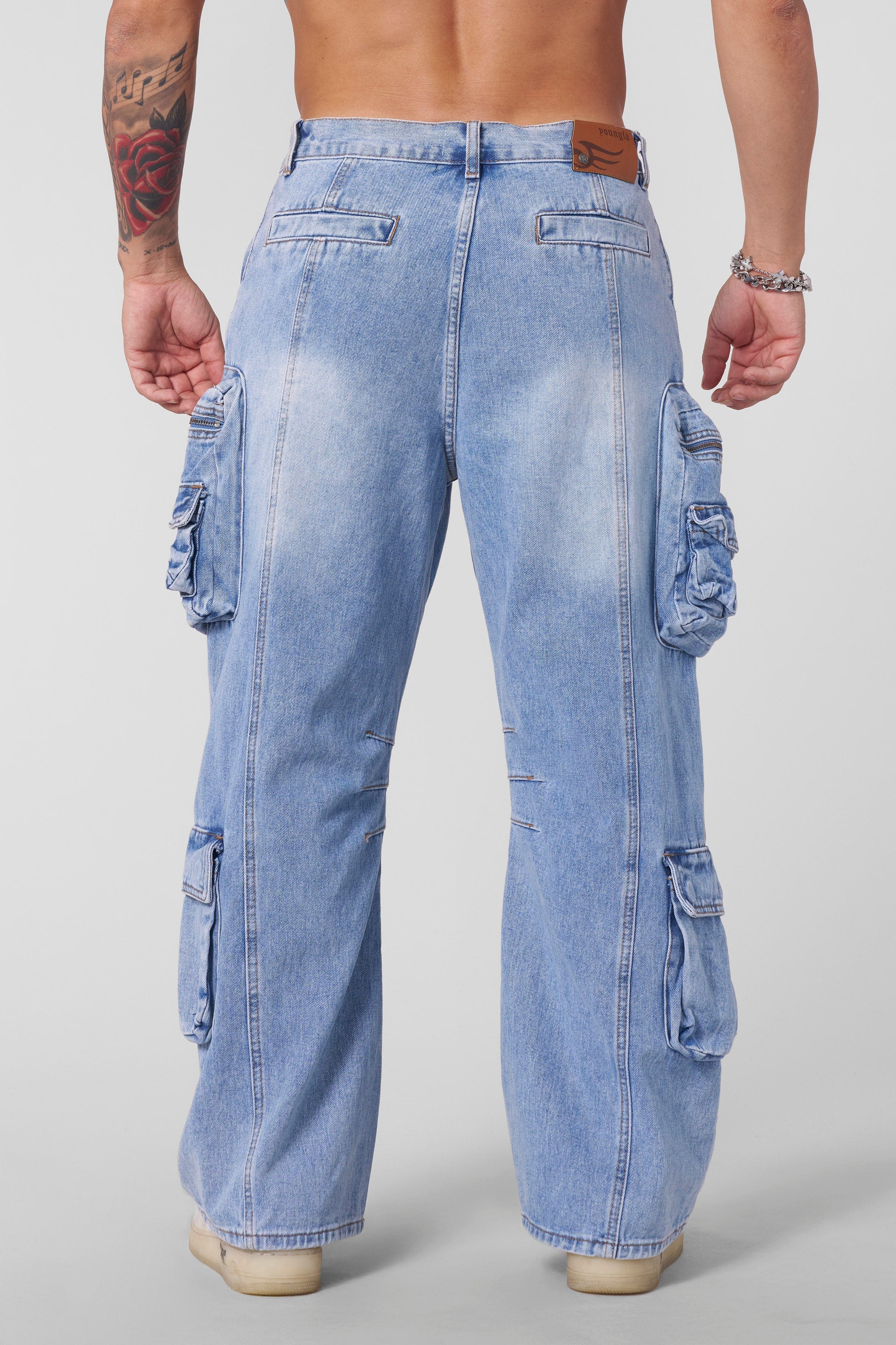Side angle of baggy stacked jeans showcasing the relaxed fit.