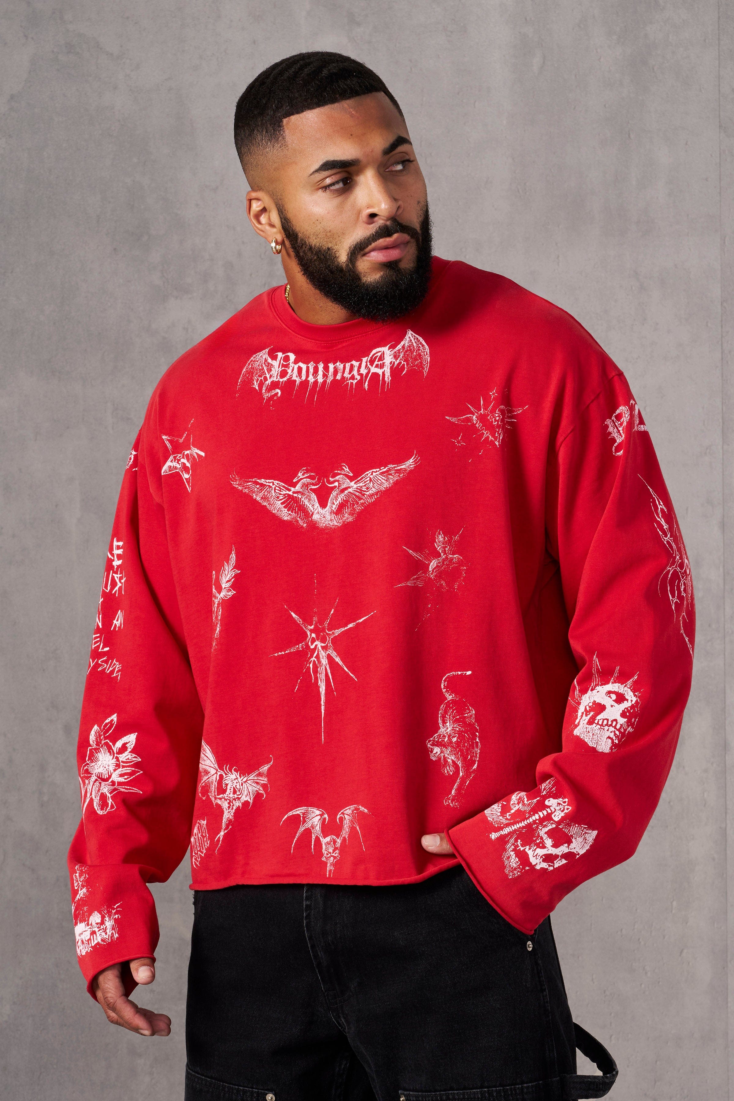 Front full-body shot showing graphic long sleeve t shirt paired with sneakers