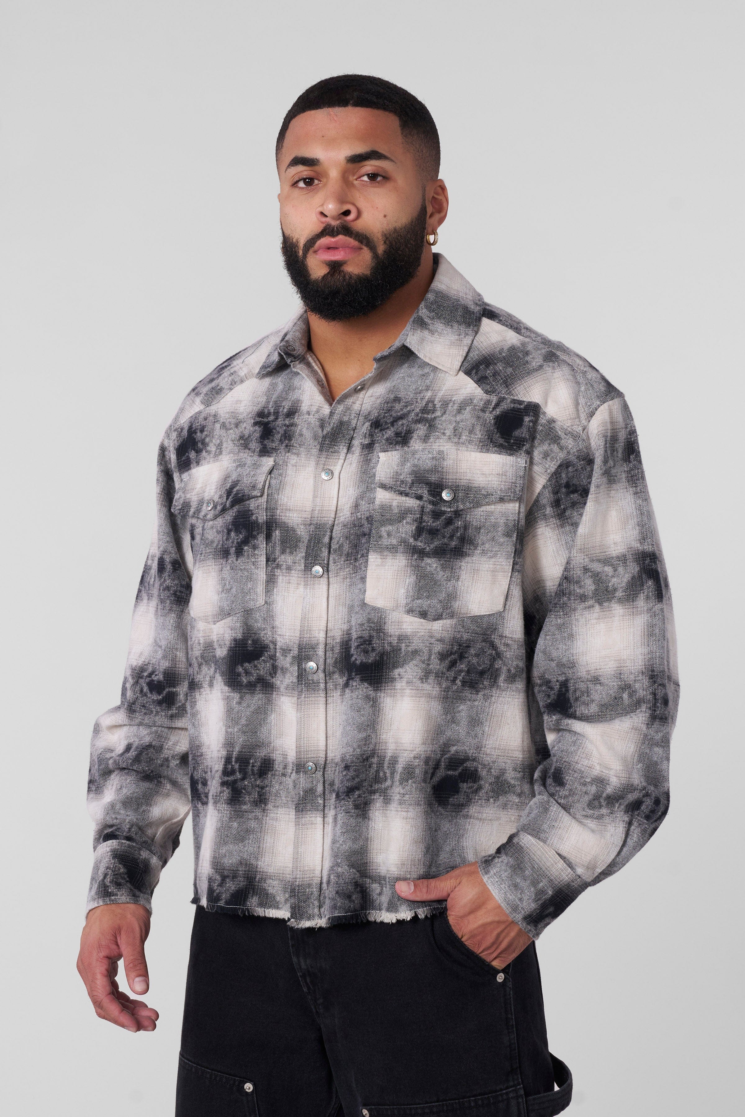 Urban Outlaw flannel shirt displayed on a hanger, highlighting its boxy fit design.