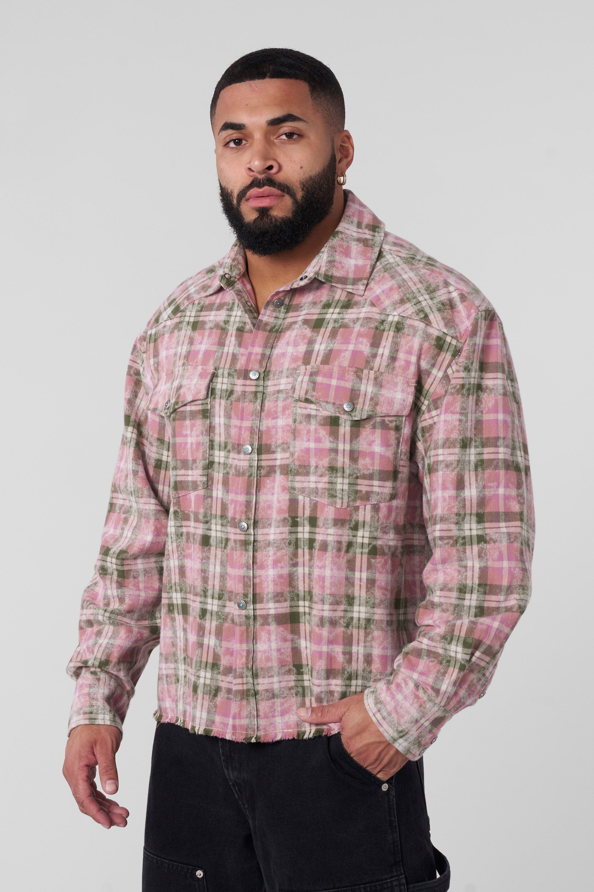 Model wearing the Urban Outlaw flannel shirt, styled for a casual outdoor look.