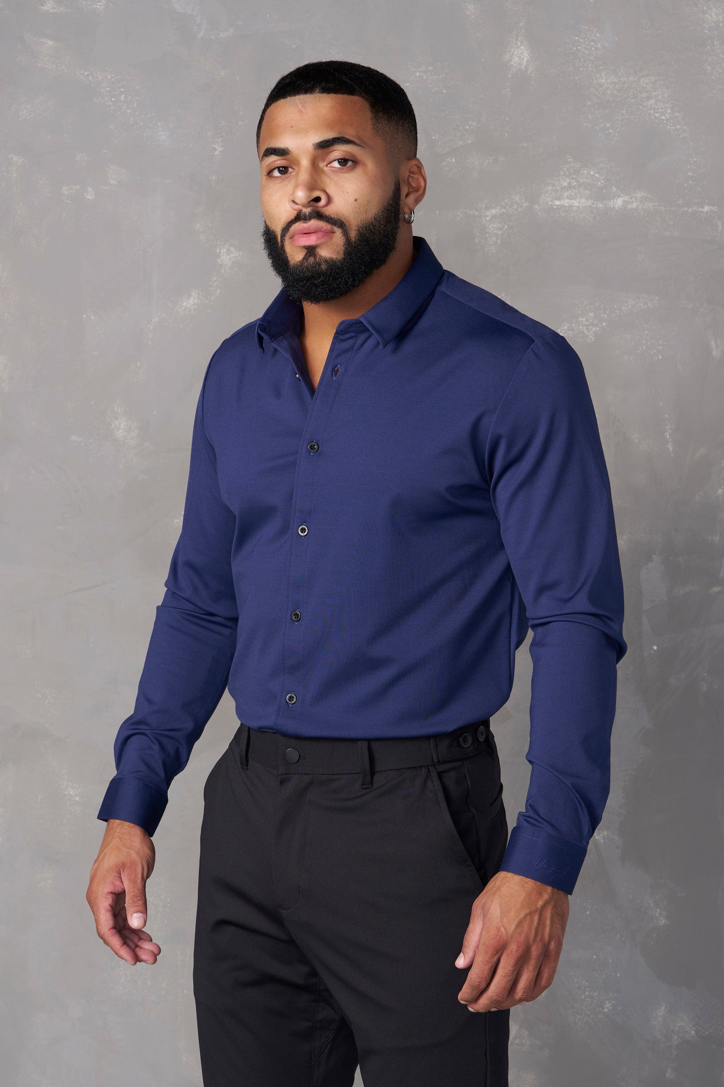 Model wearing a mens dress shirt paired with office tech pants.