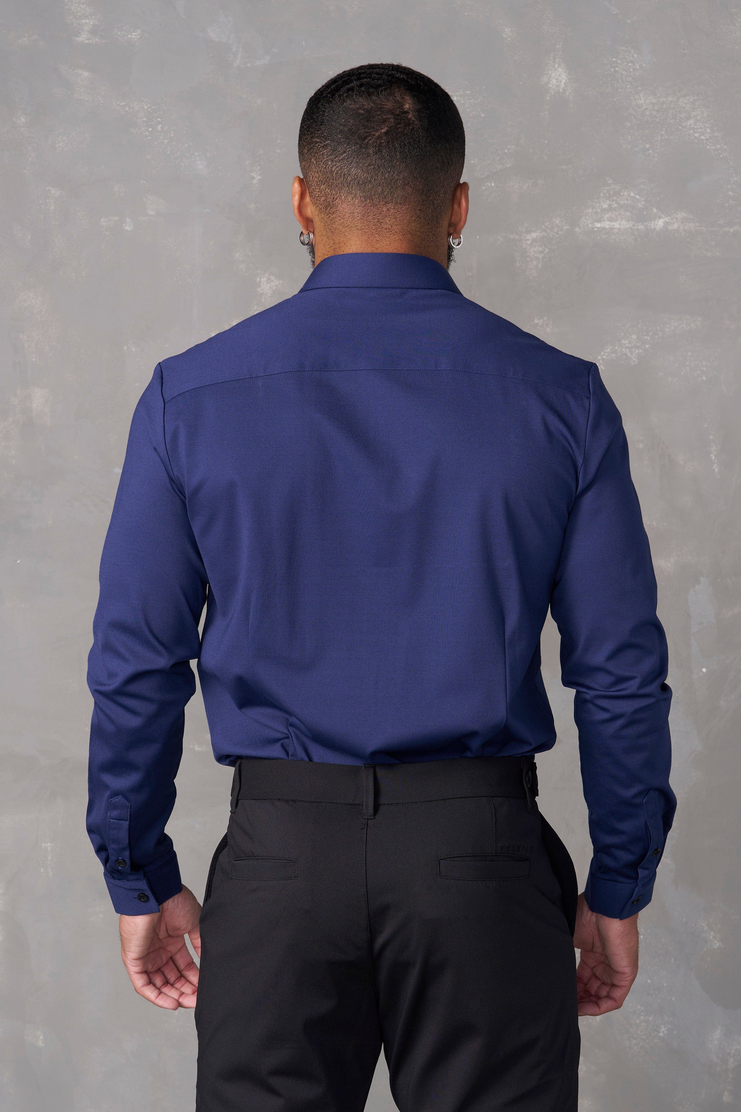 Detail of the shirts collar and buttons, highlighting its tailored design.