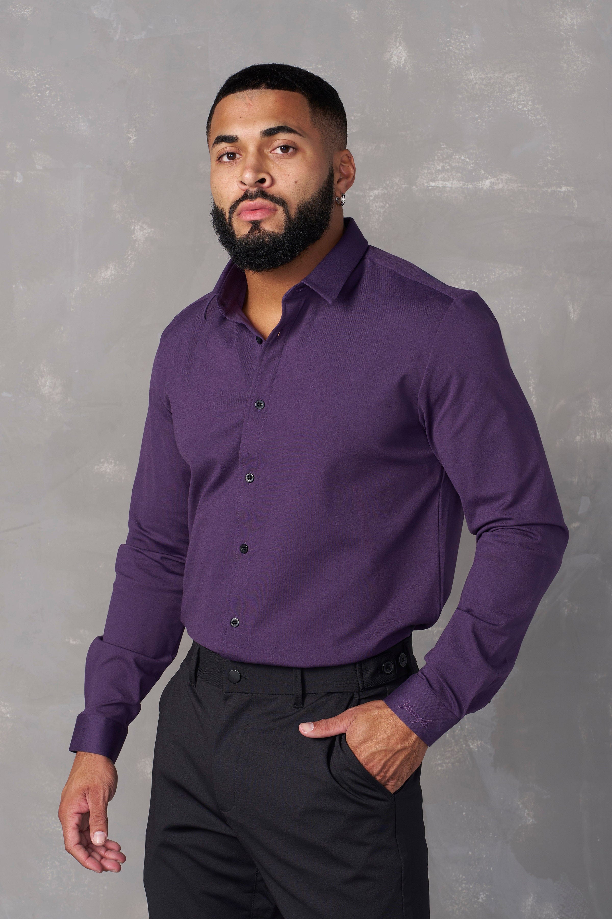 Detail of the shirts collar and buttons, highlighting its tailored design.