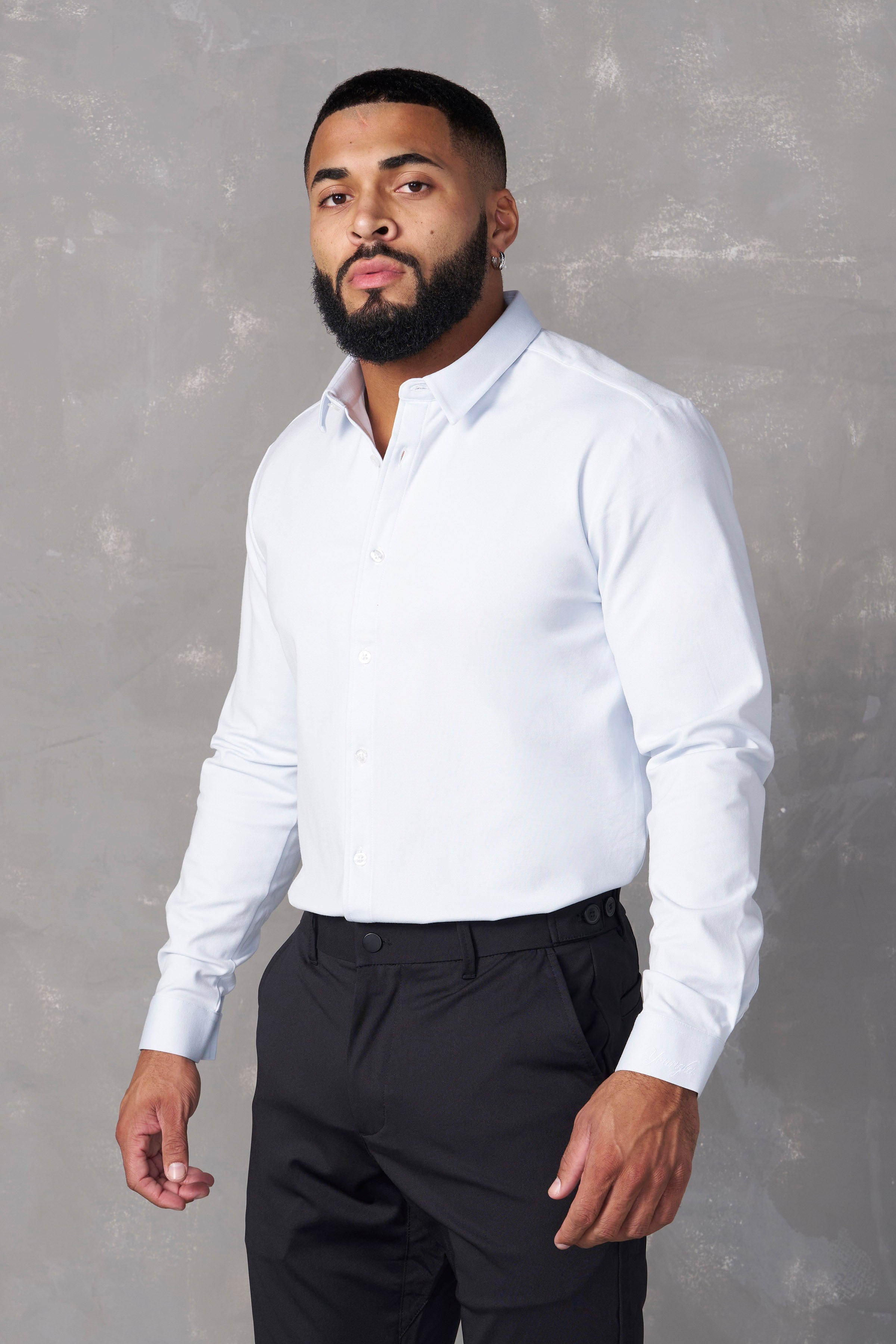 Model wearing a mens dress shirt paired with office tech pants.