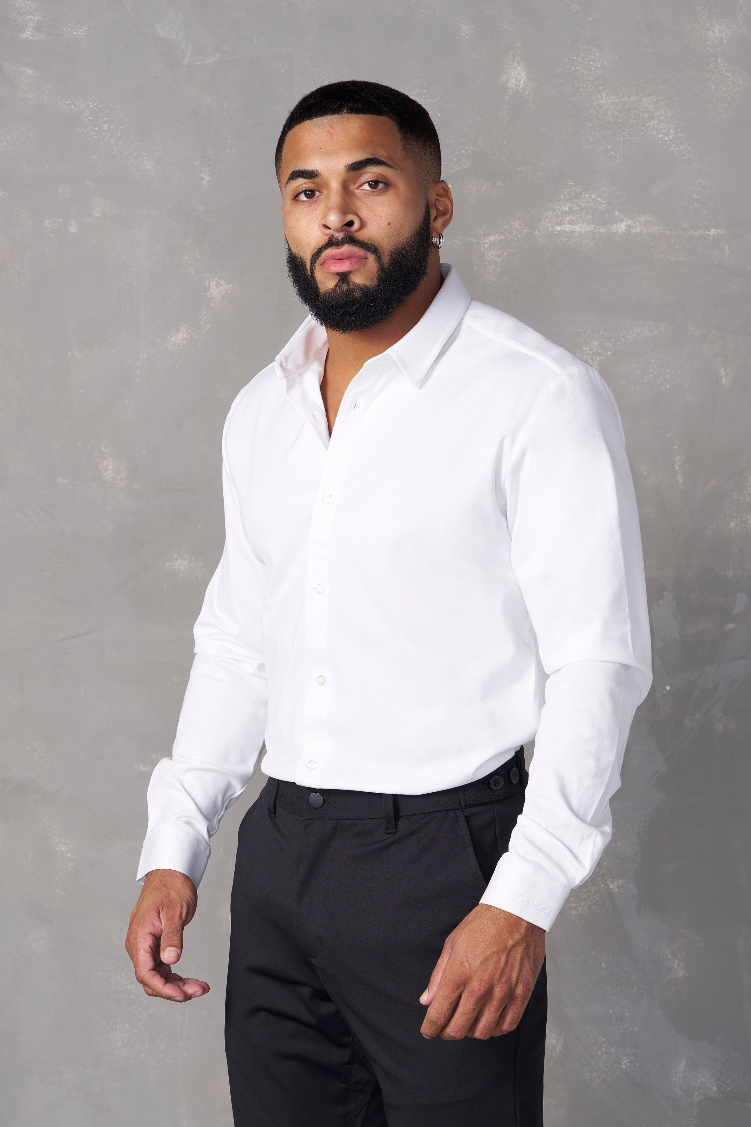 Detail of the shirts collar and buttons, highlighting its tailored design.