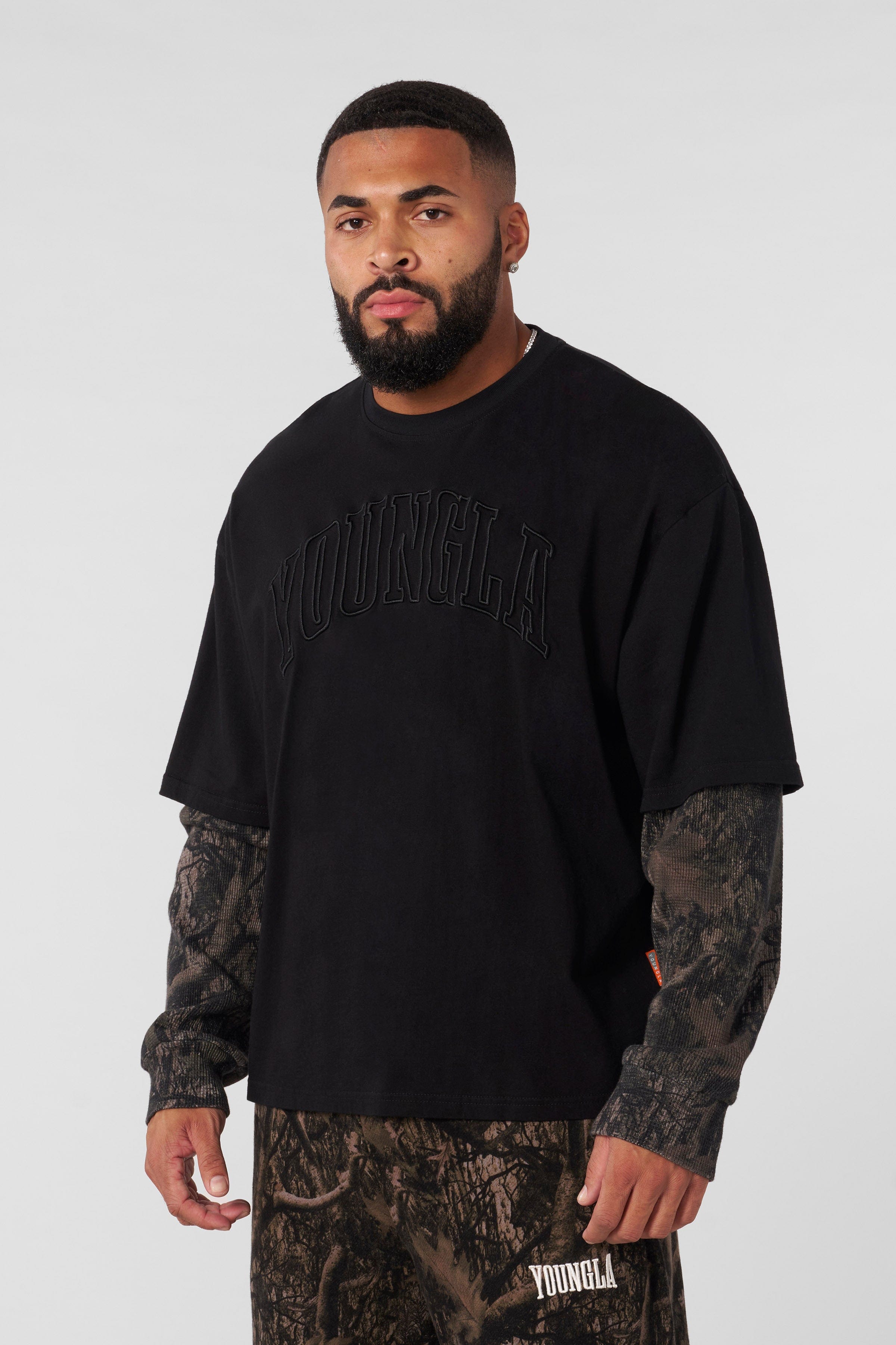 Front view of the tree camo long sleeve twofer shirt, showcasing the camo sleeves.