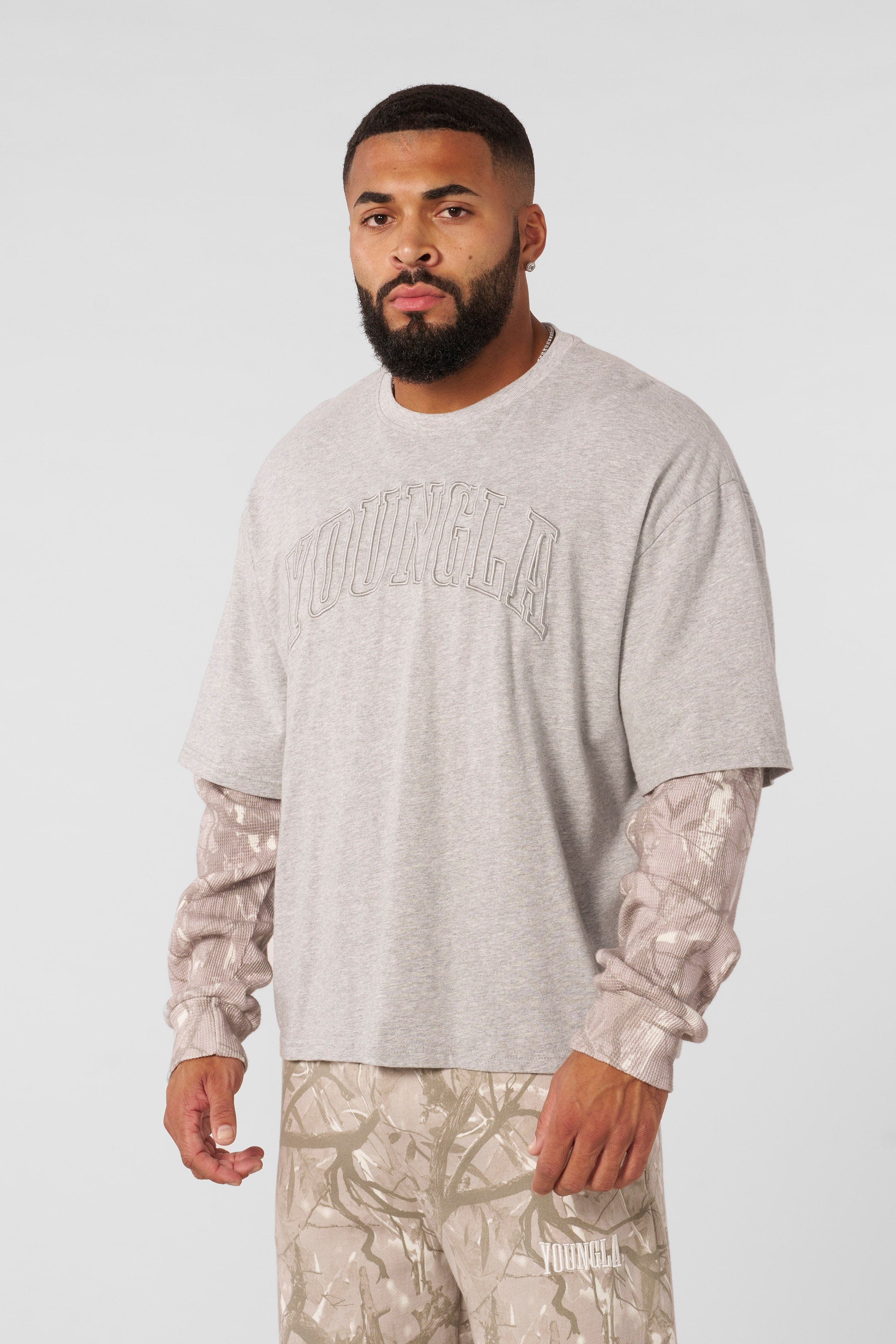 Front view of the tree camo long sleeve twofer shirt, showcasing the camo sleeves.