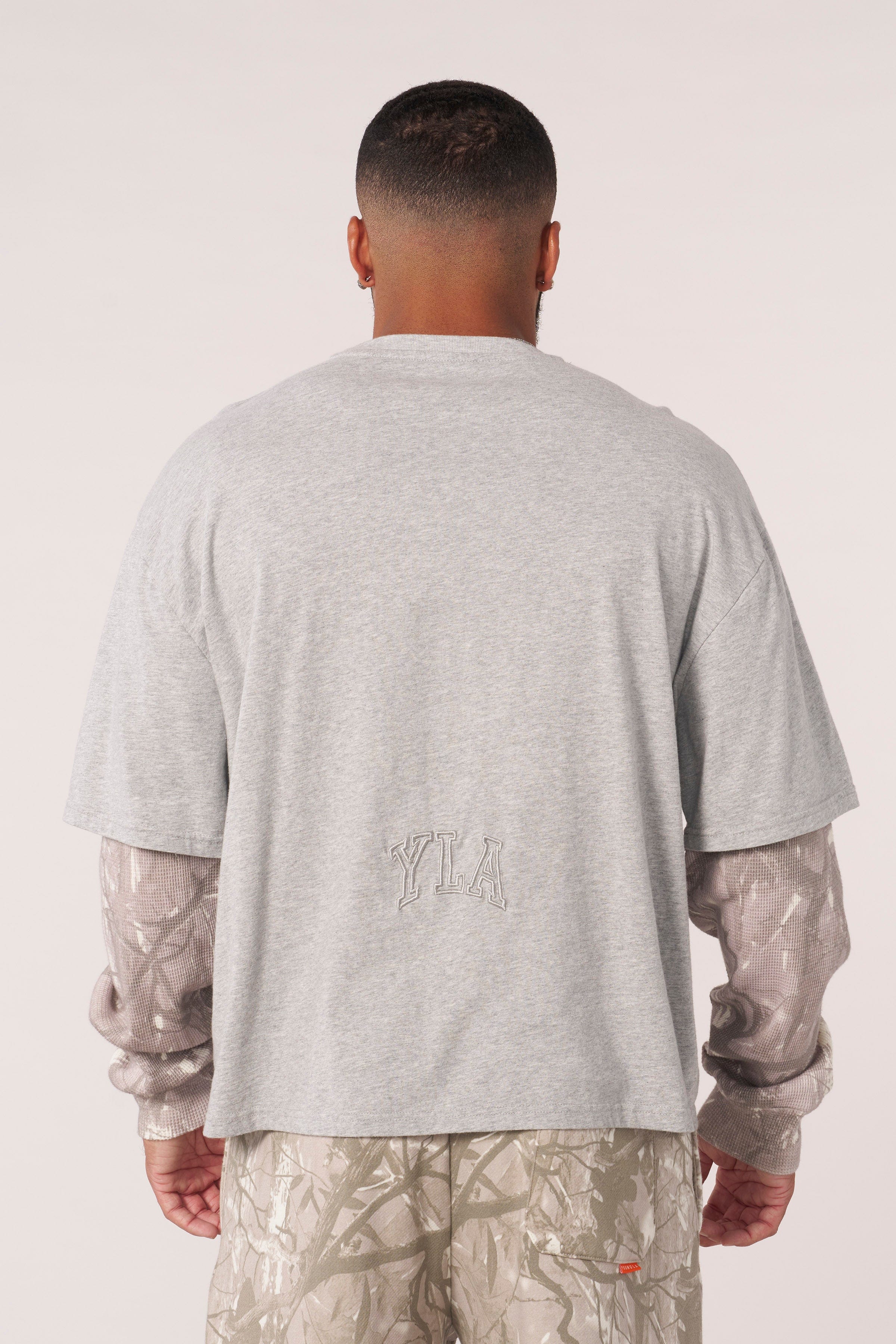 Front view of the tree camo long sleeve twofer shirt, showcasing the camo sleeves.