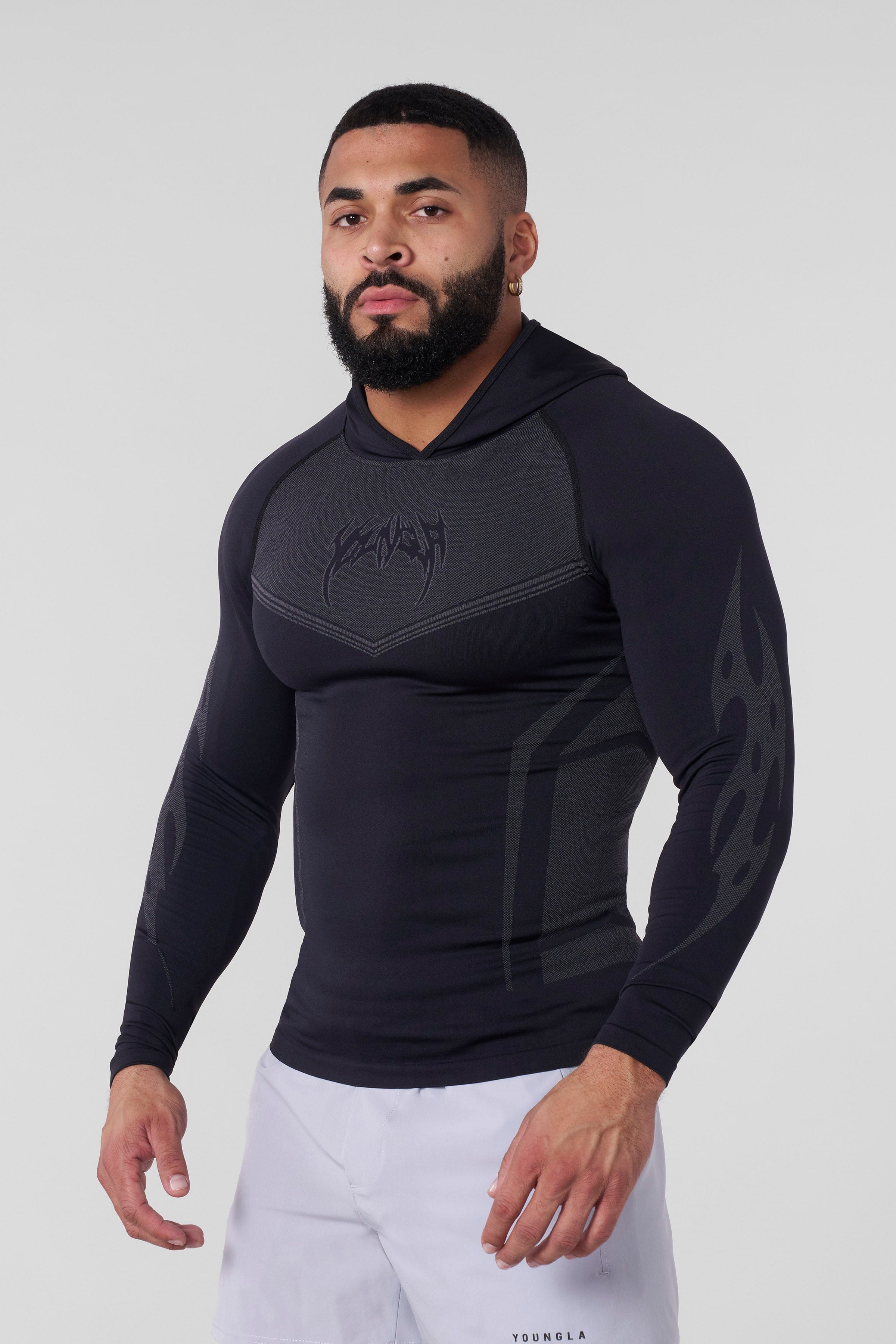 Model wearing the lightweight performance hoodie during a workout session.