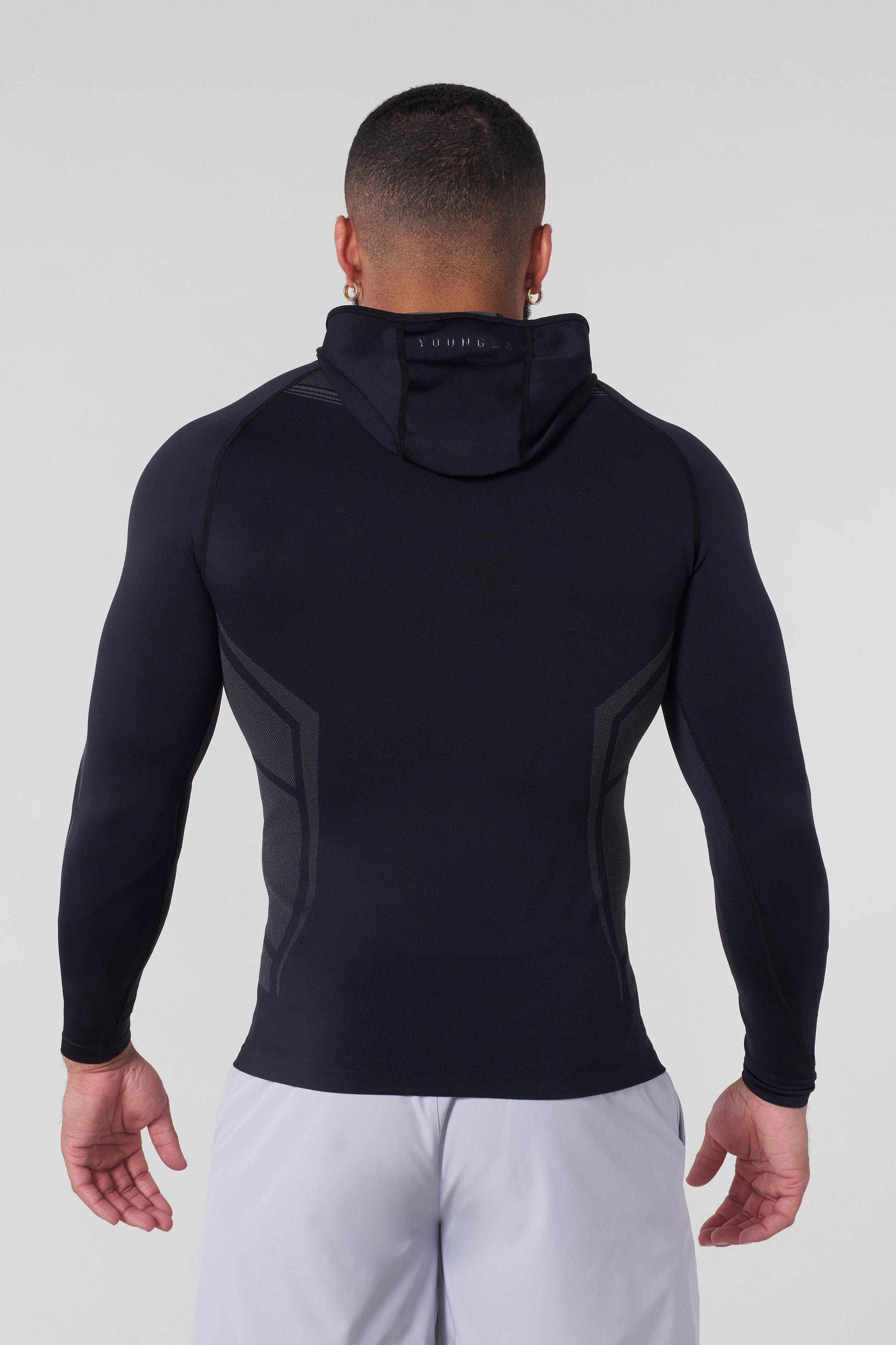 Model wearing the lightweight performance hoodie during a workout session.