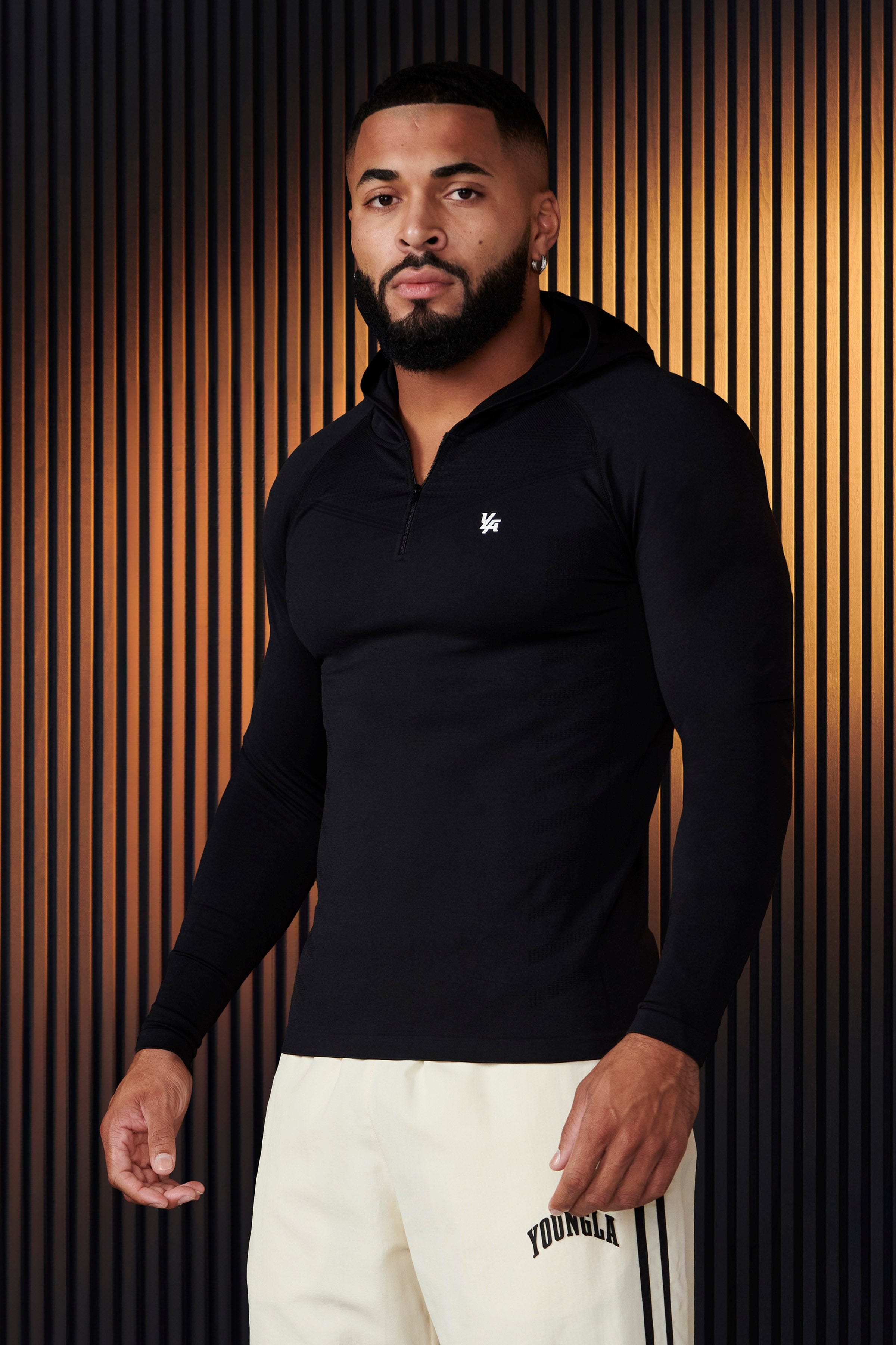 Back profile of no sleeve hoodie workout style showing design contours and brand detailing.