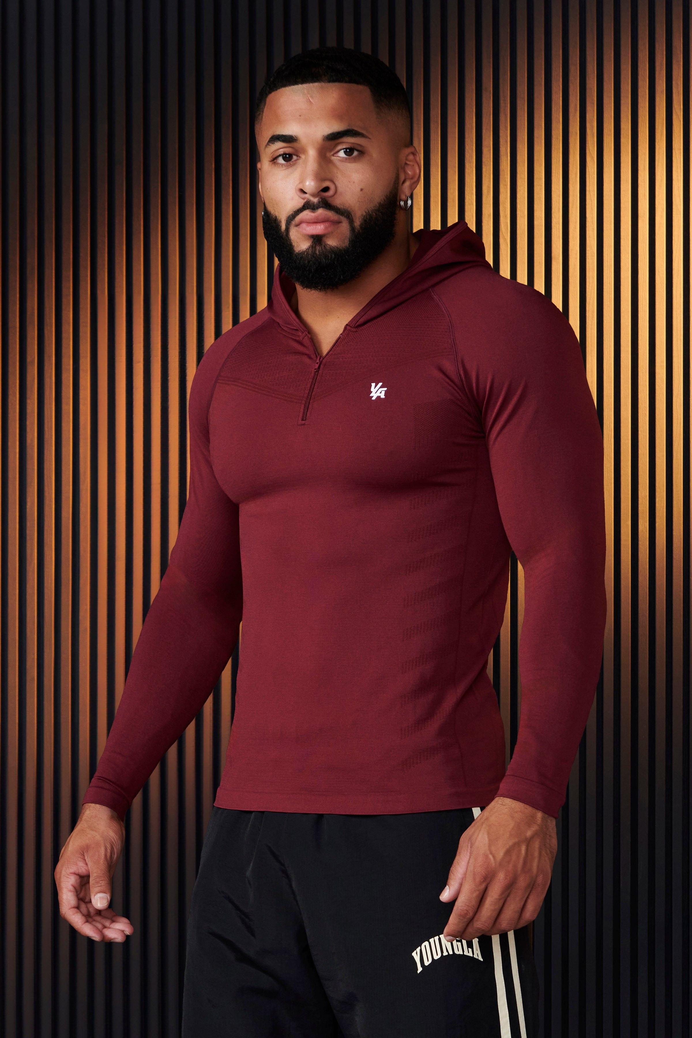 Front view of sleeveless workout hoodie worn by male model during a sunrise run.