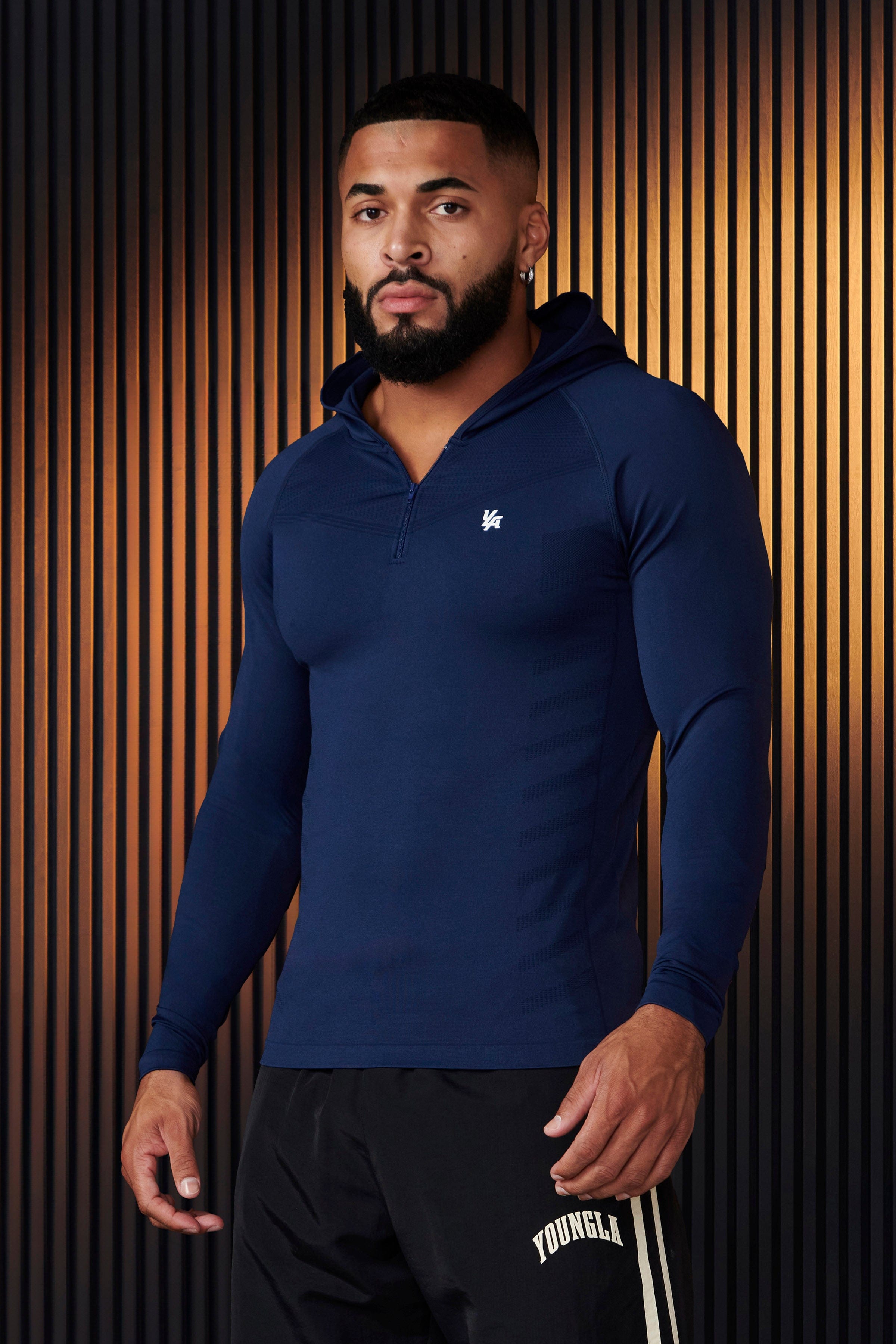 Front view of sleeveless workout hoodie worn by male model during a sunrise run.