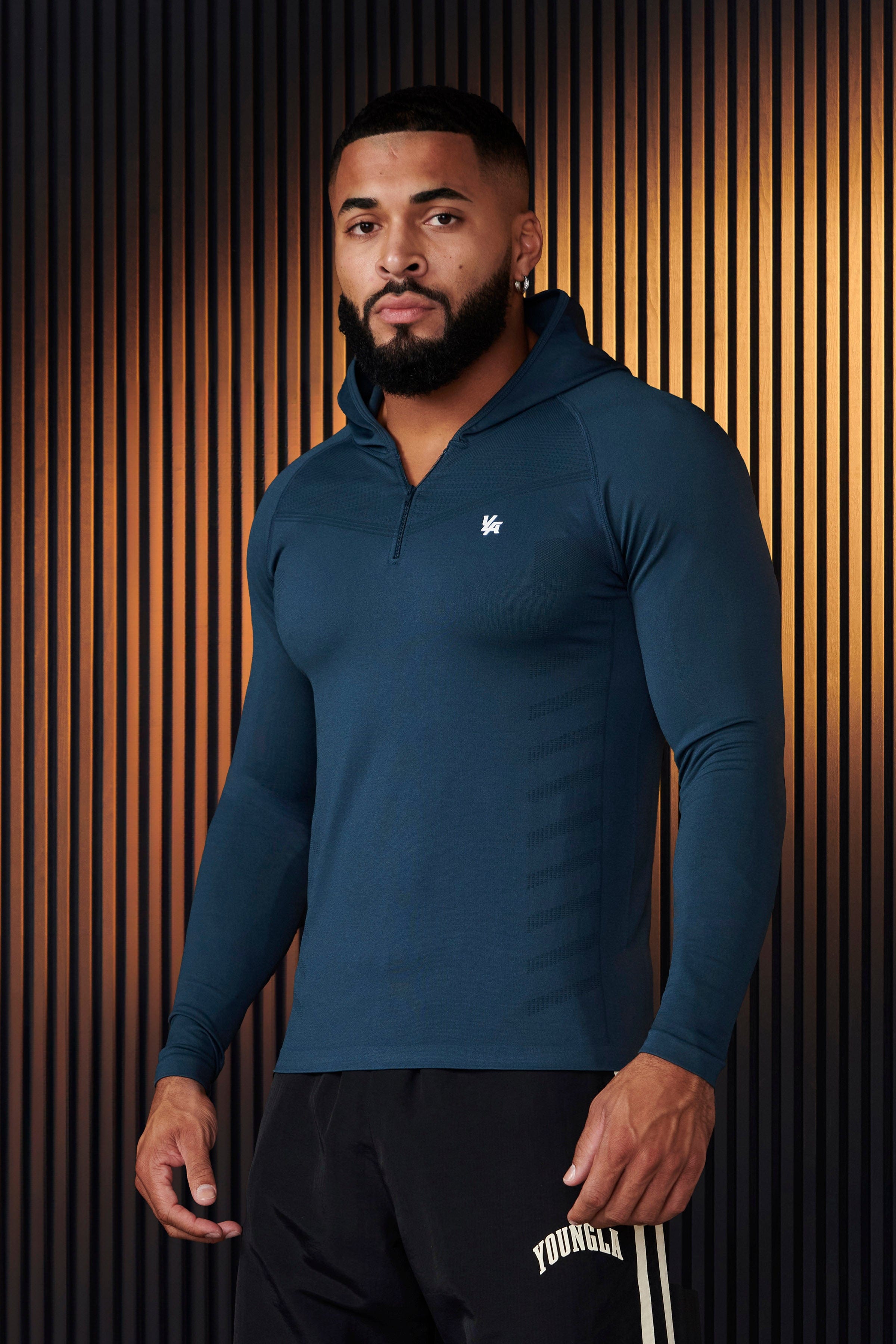 Back profile of no sleeve hoodie workout style showing design contours and brand detailing.