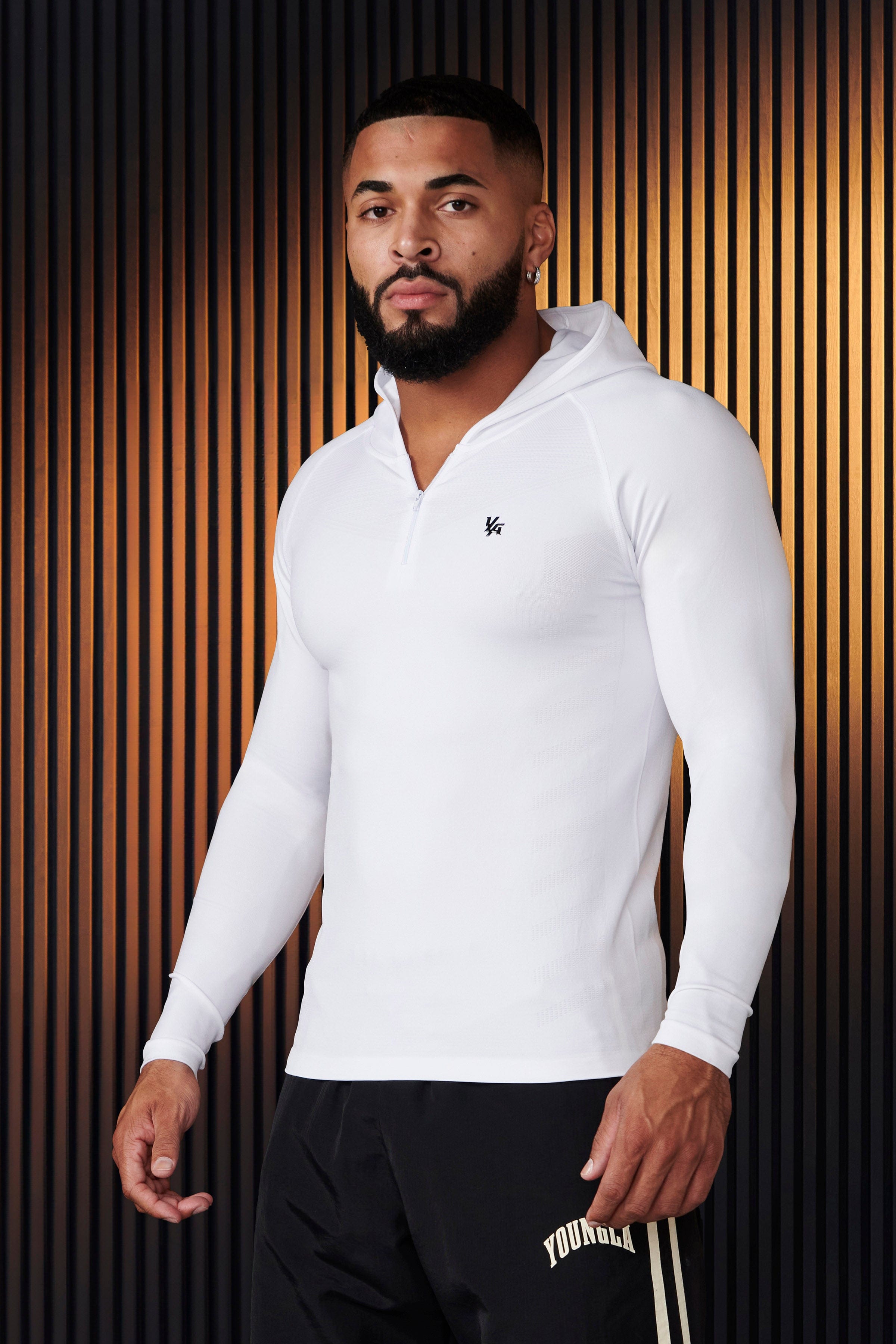 Front view of sleeveless workout hoodie worn by male model during a sunrise run.