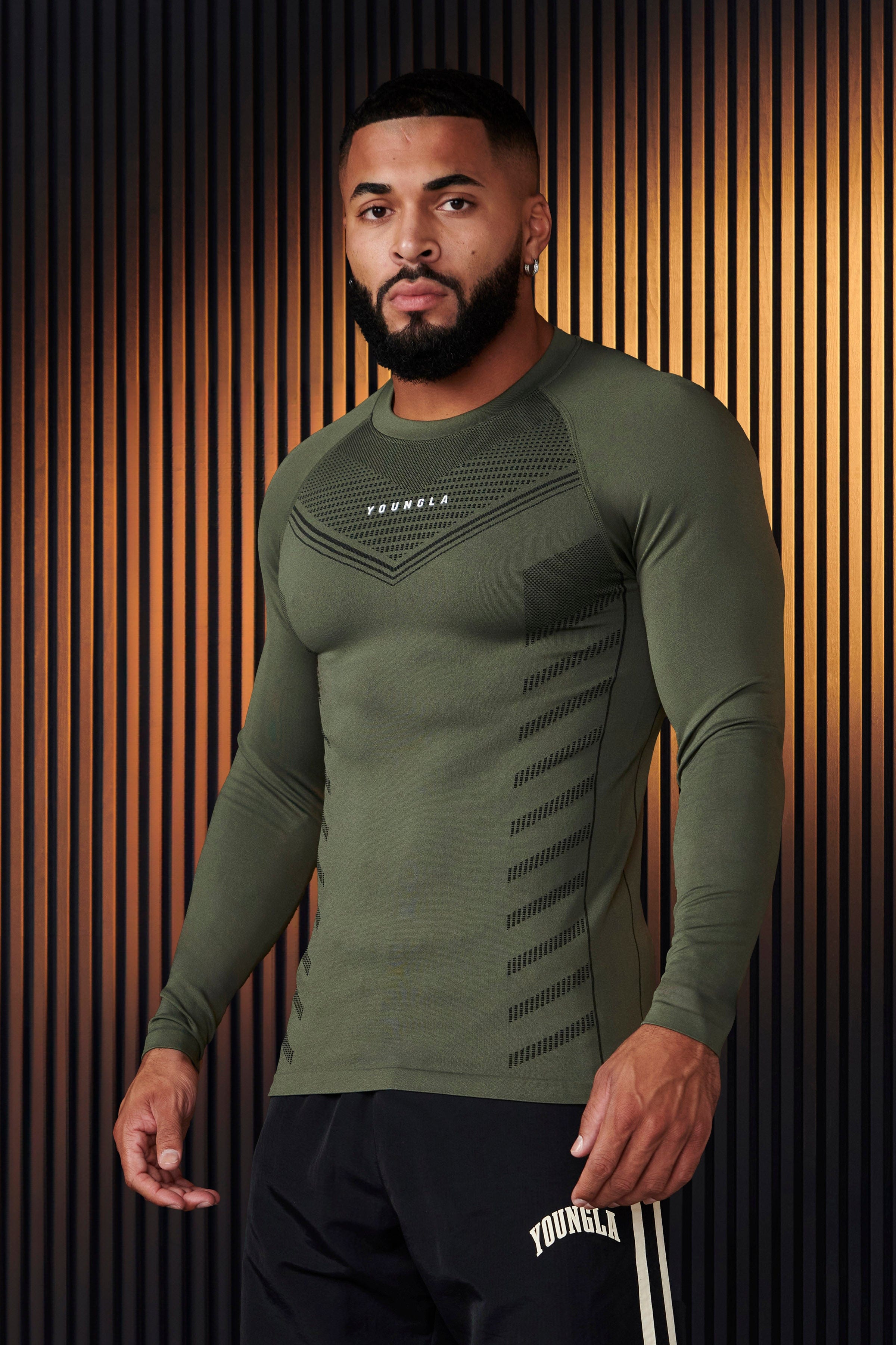 Men's compression shirt showcasing moisture-wicking technology during workout.